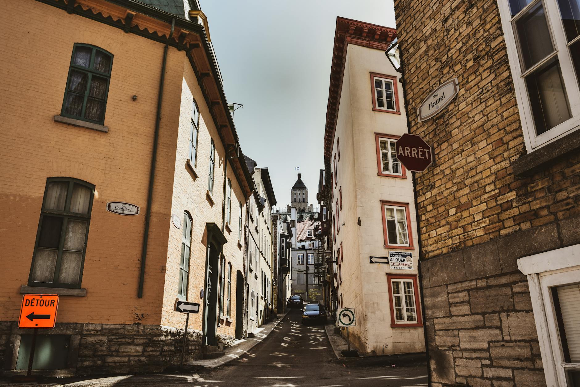 Historic alleyway in Quebec City under clear sky