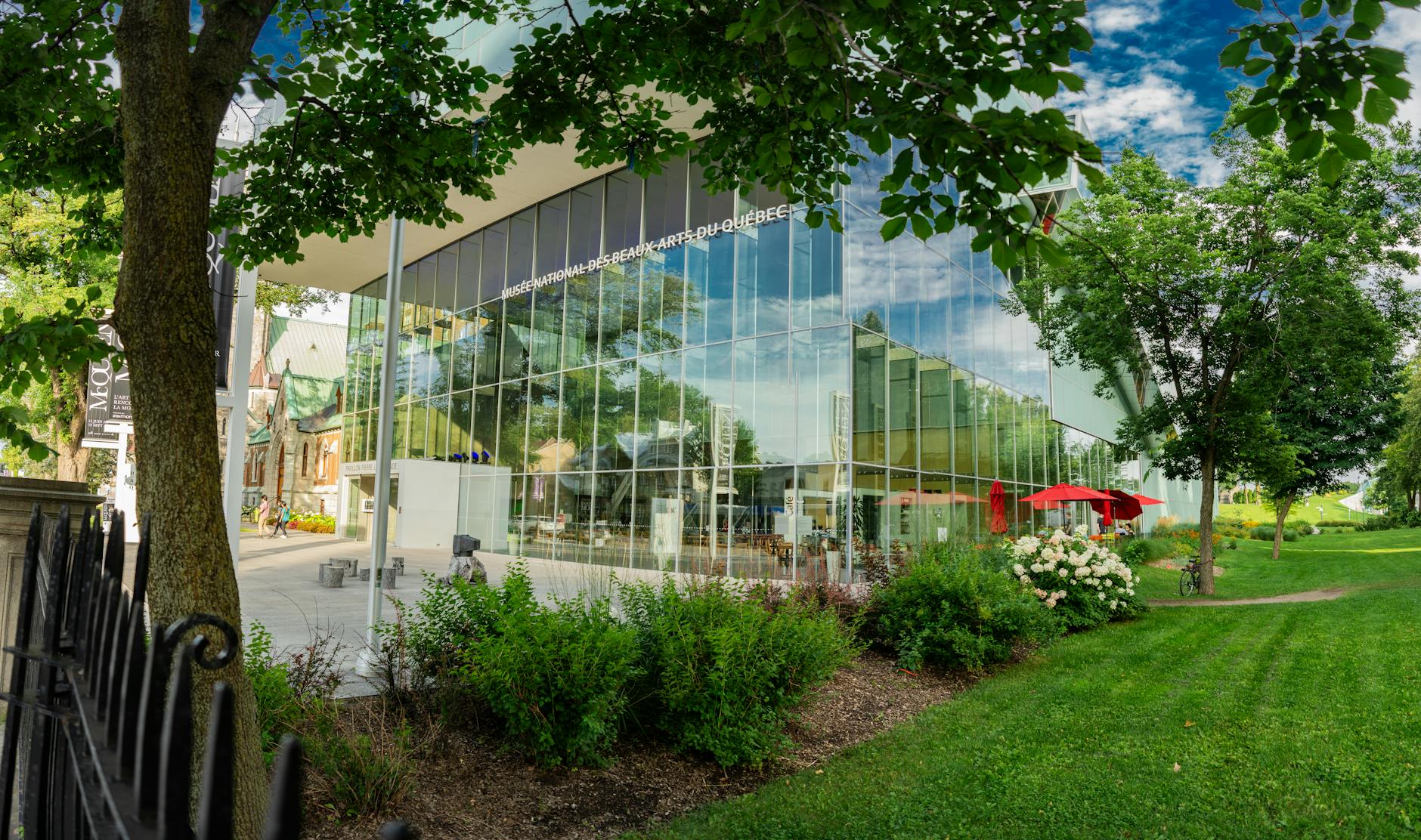 Modern glass building surrounded by greenery in Quebec