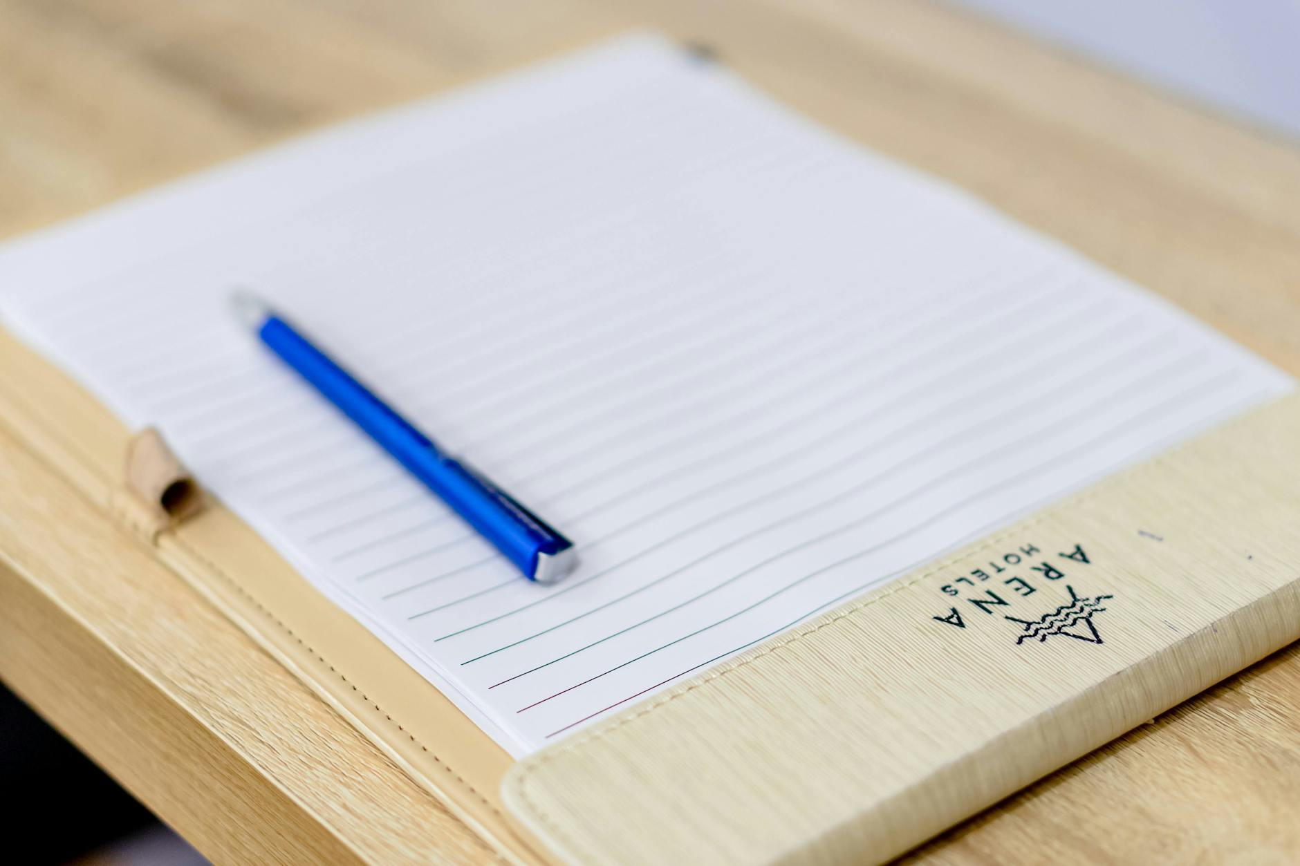 Pen and notebook on a wooden desk