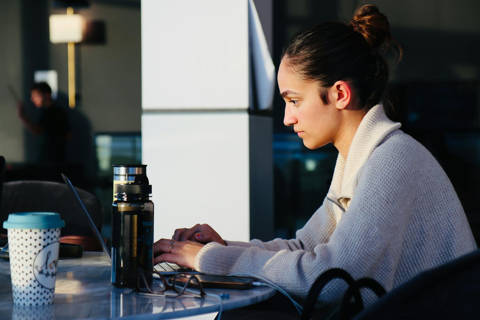 Woman using a laptop at a cafe in Quebec