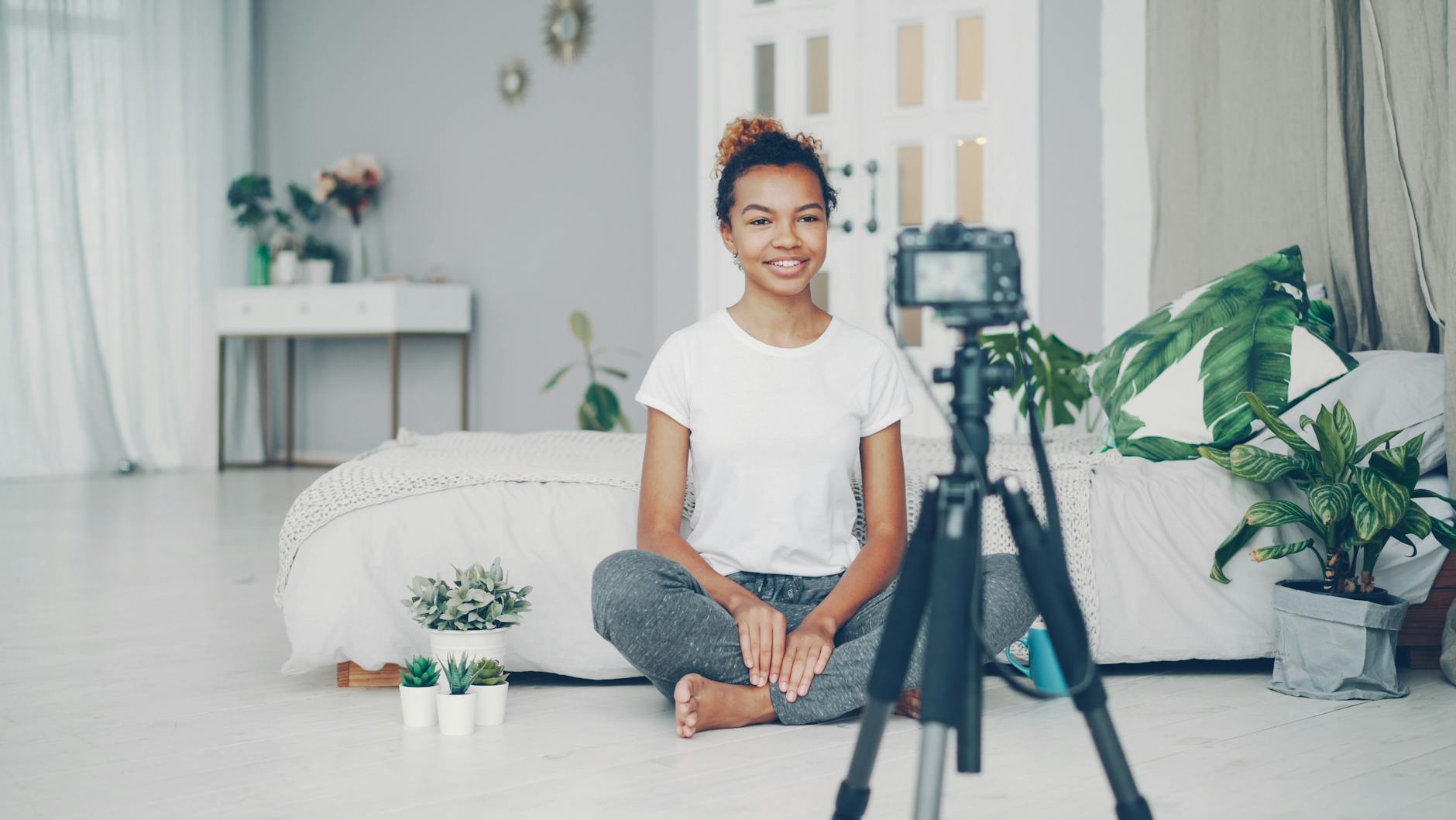 Woman filming a vlog in a cozy indoor setting