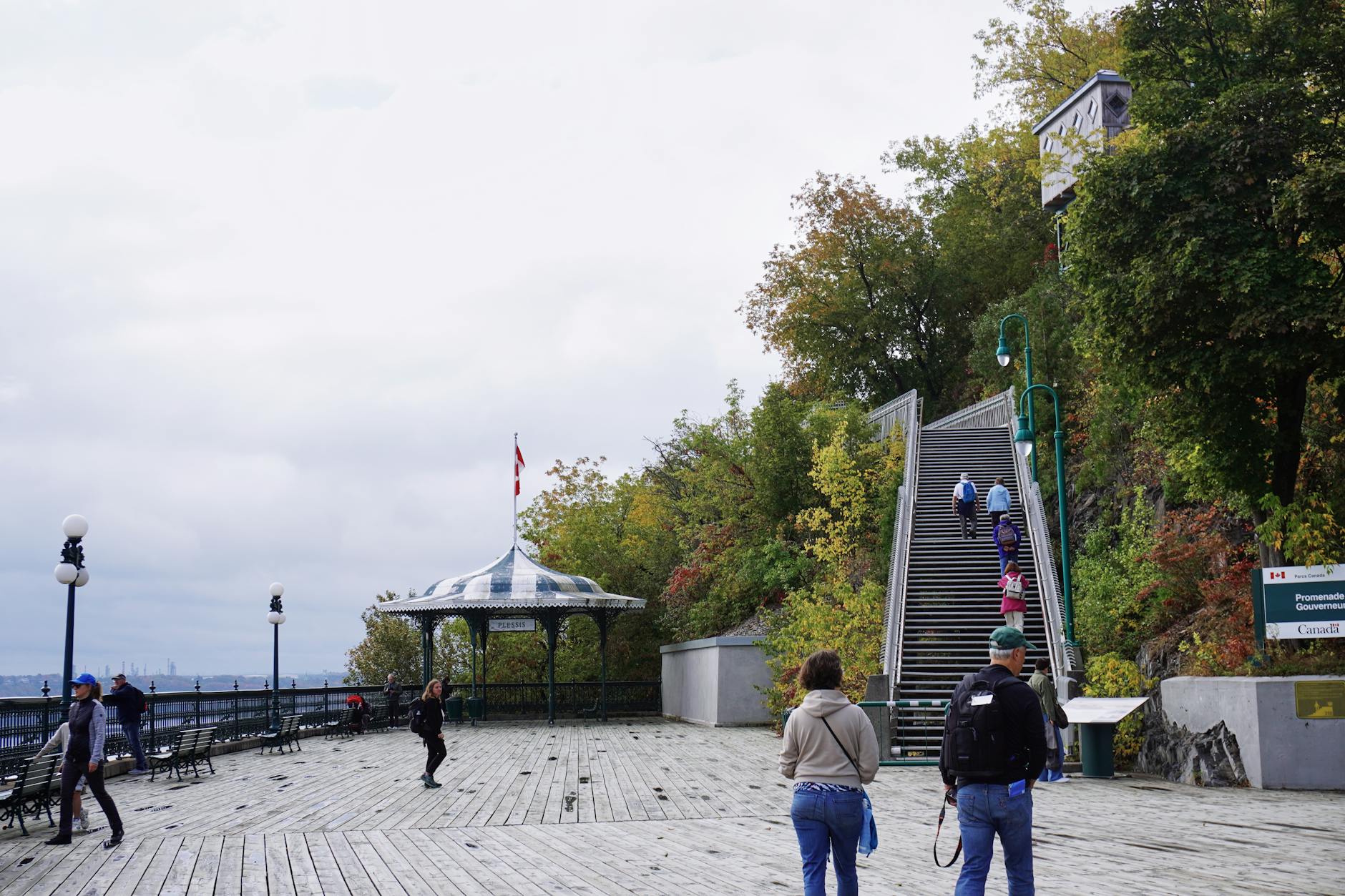 People enjoying the fall view from Terrasse Dufferin in Quebec City