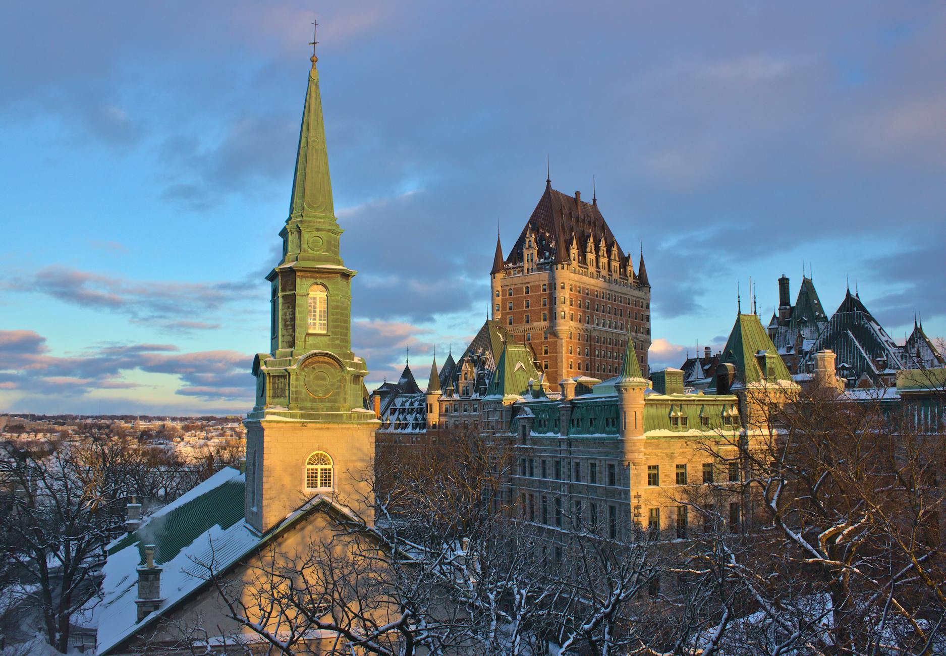 Chateau Frontenac and Old Quebec at sunset framed by snow