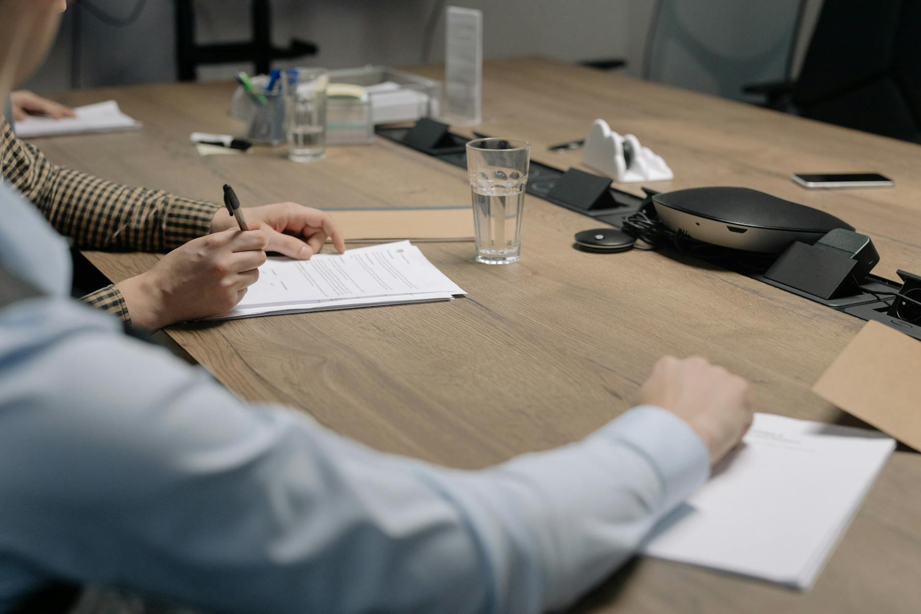 Business meeting with documents being signed on a conference table