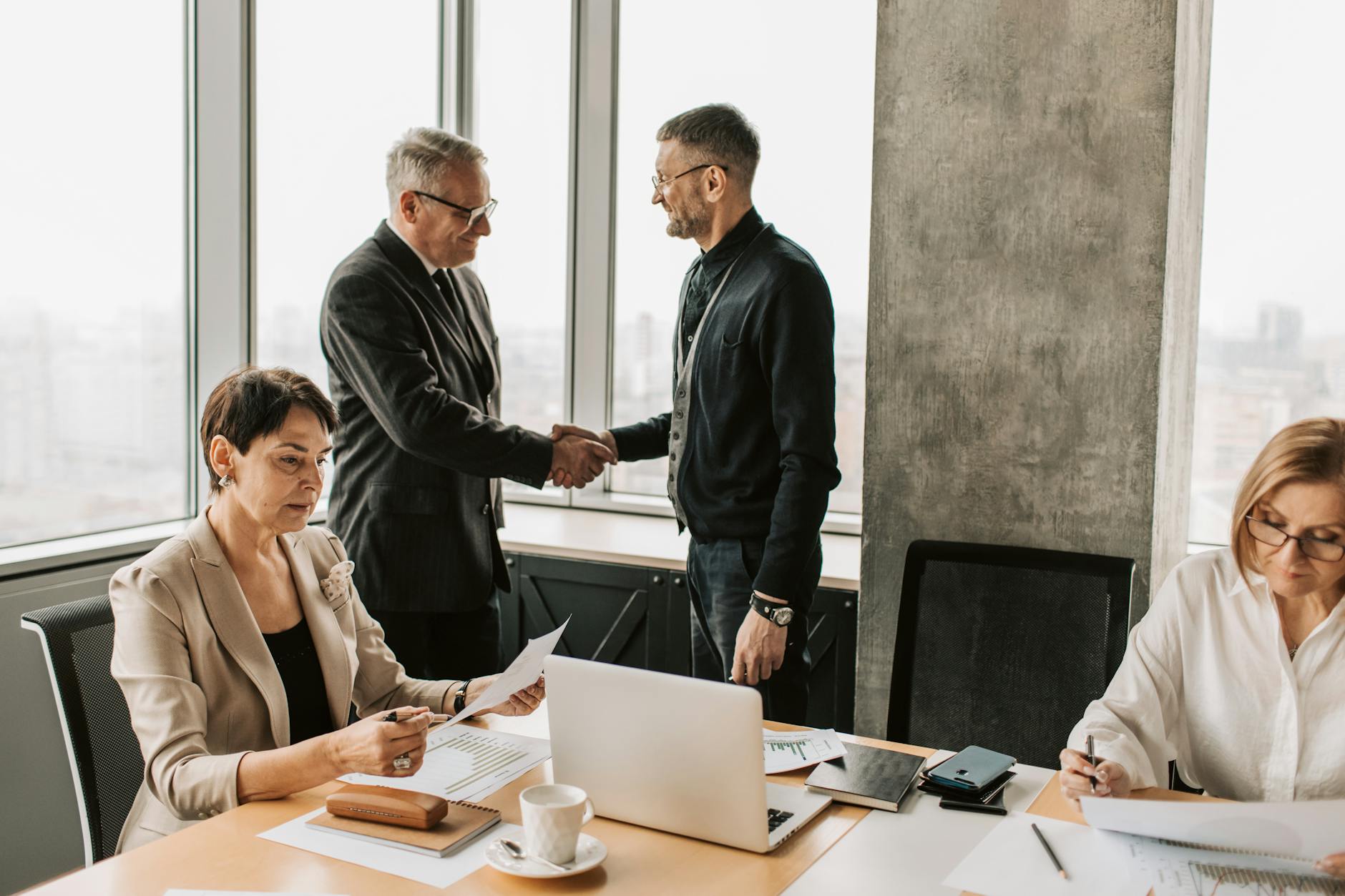 Professional business meeting with handshake in a modern office