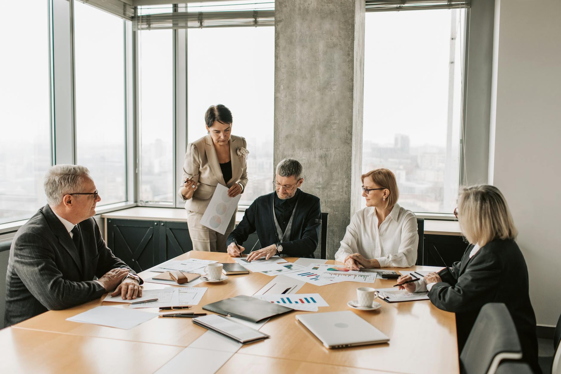 Professionals discussing documents during a business meeting