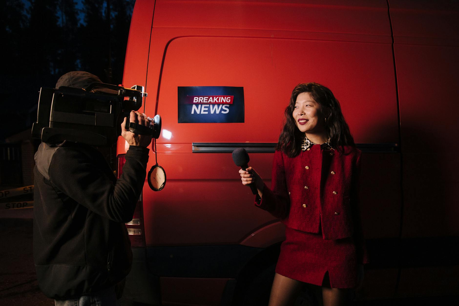 News reporter holding a microphone during an outdoor broadcast