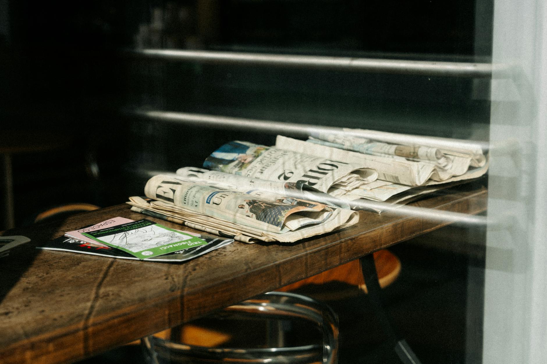 Stack of newspapers on a cafe table in Quebec