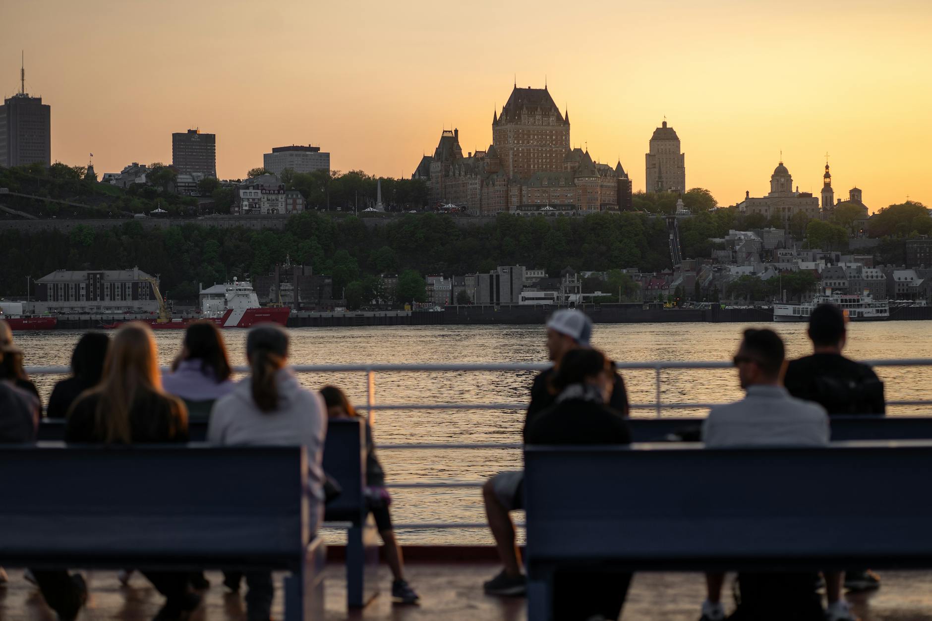 Chateau Frontenac and Quebec City skyline at sunset from a waterfront terrace