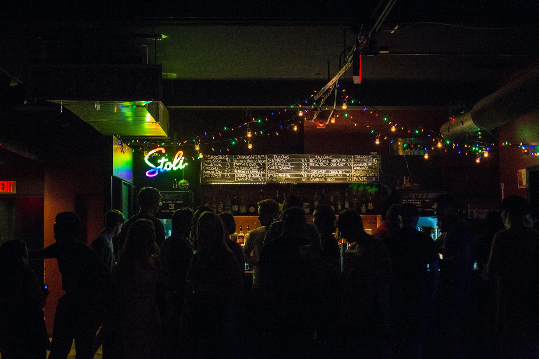 Nightclub crowd under festive string lights