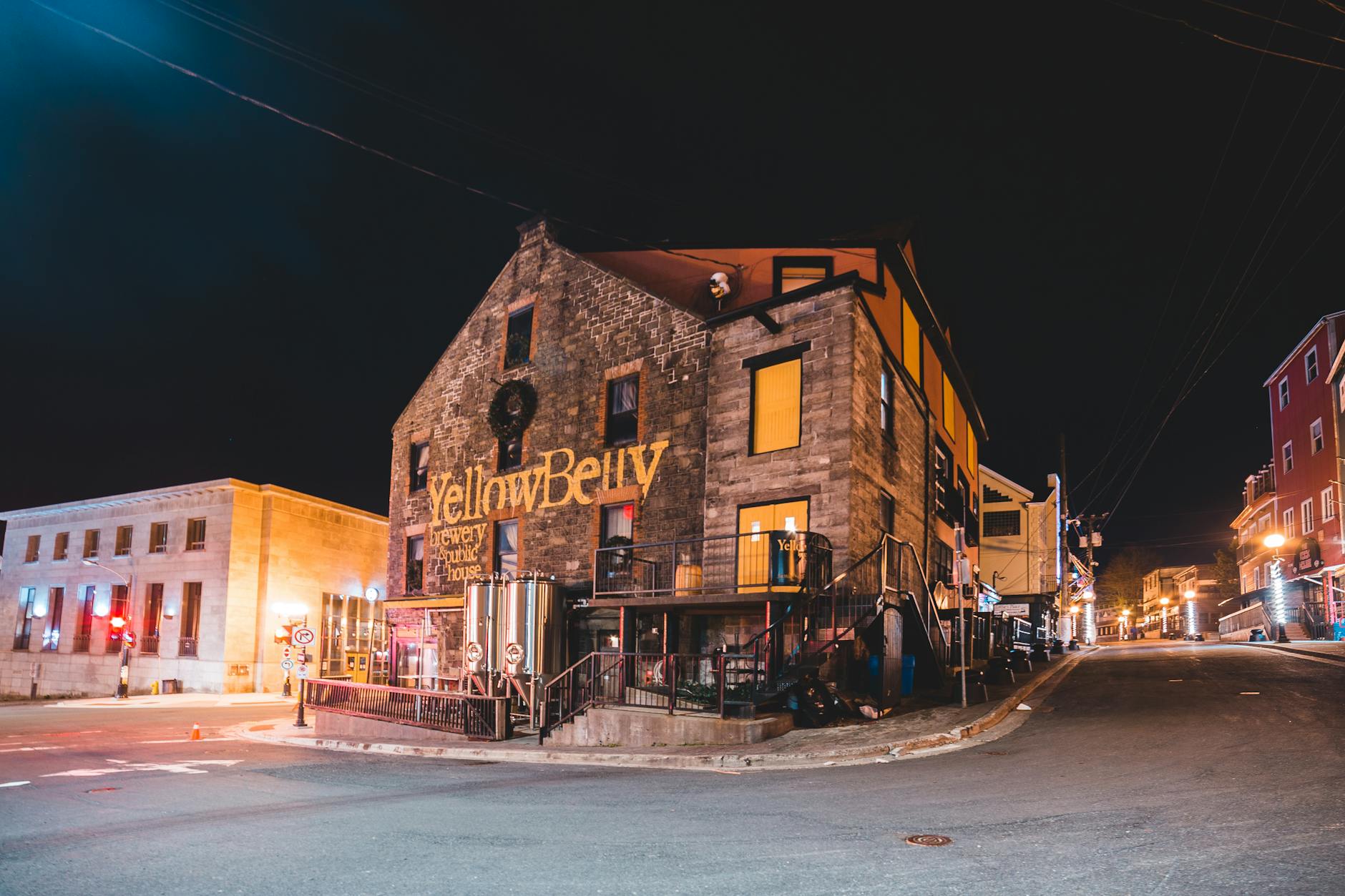 Cafe exterior illuminated at dusk in an old city street