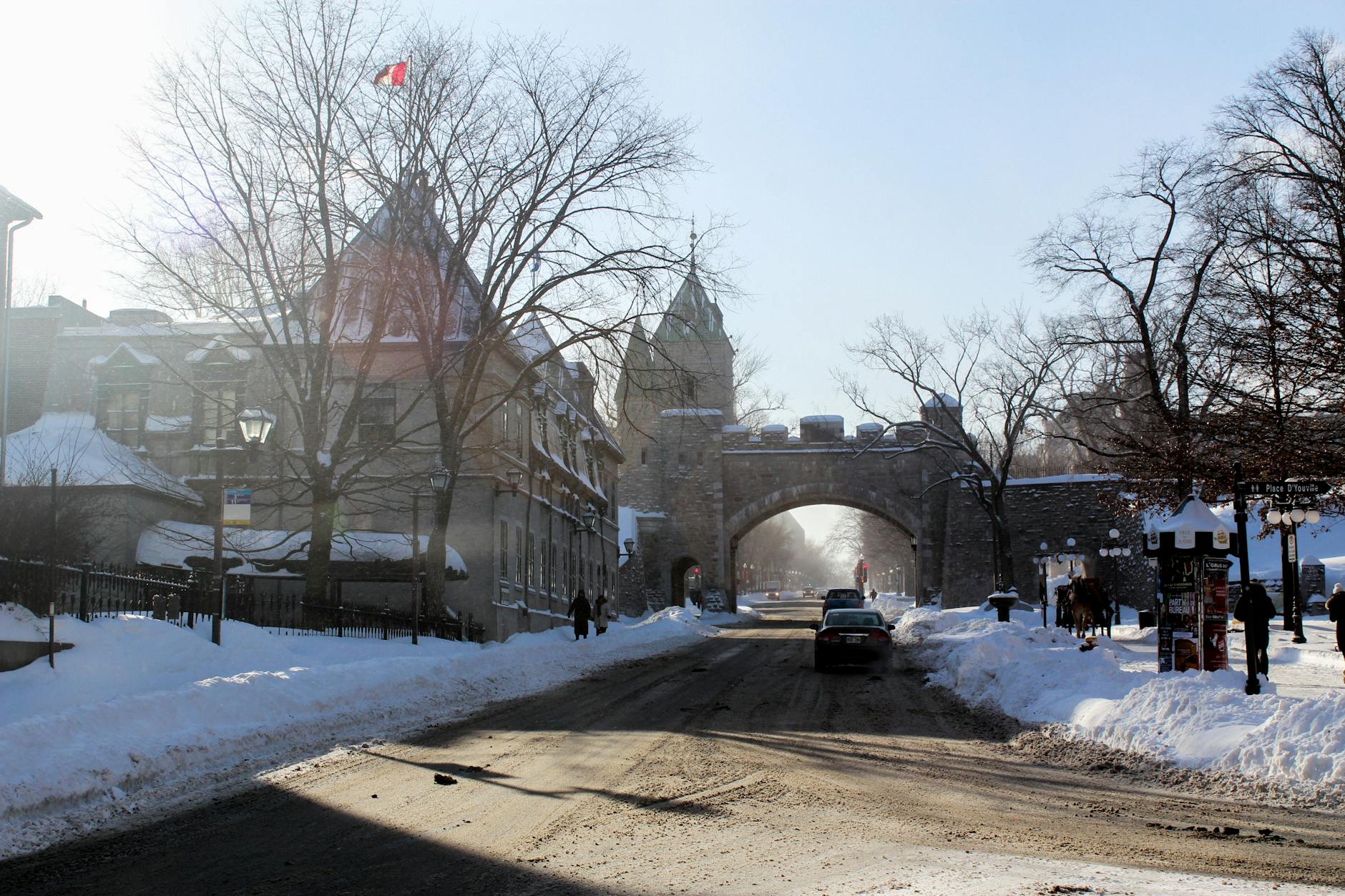 Snow-covered Old Quebec street with a historic gate