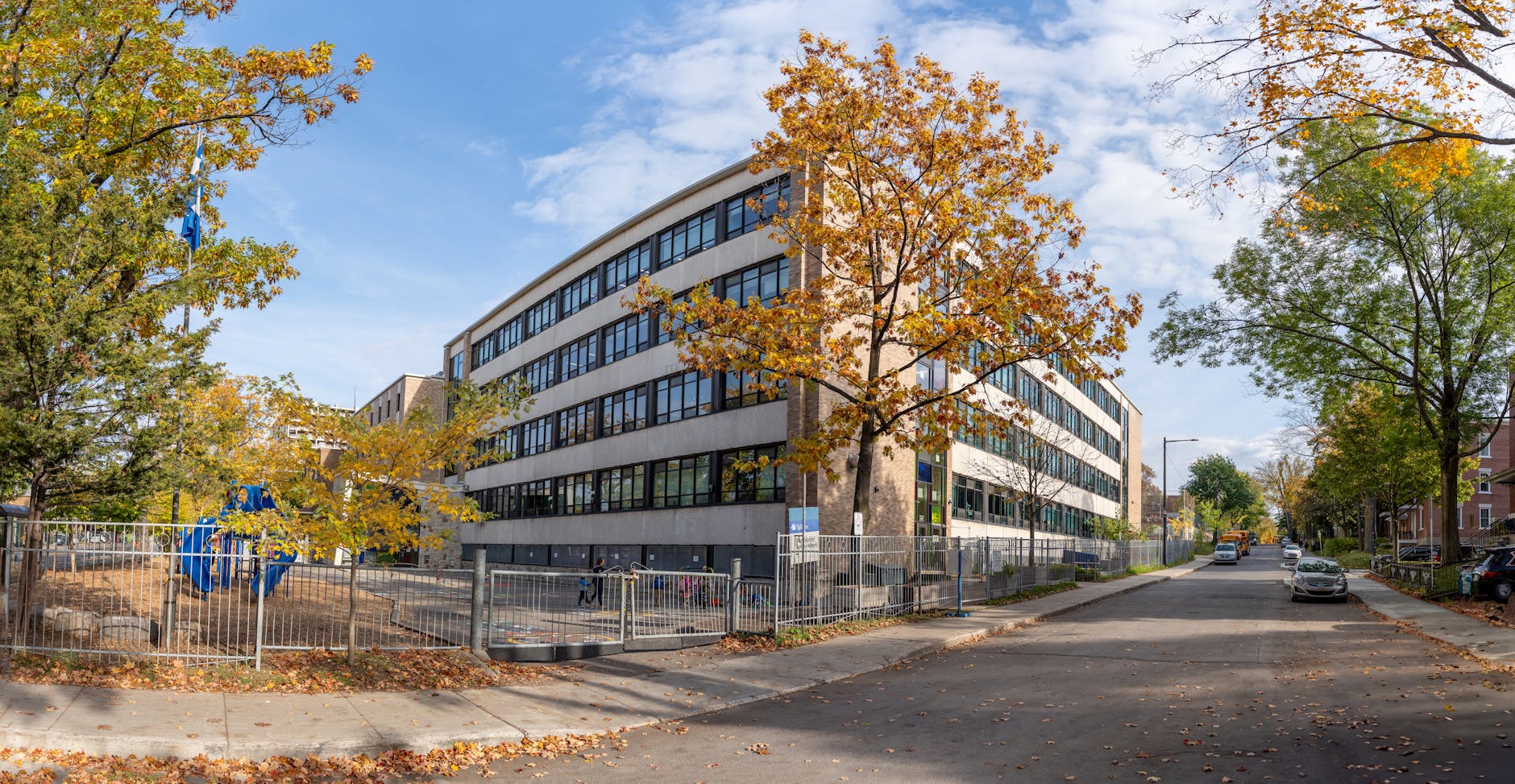 Quebec City school building surrounded by autumn trees