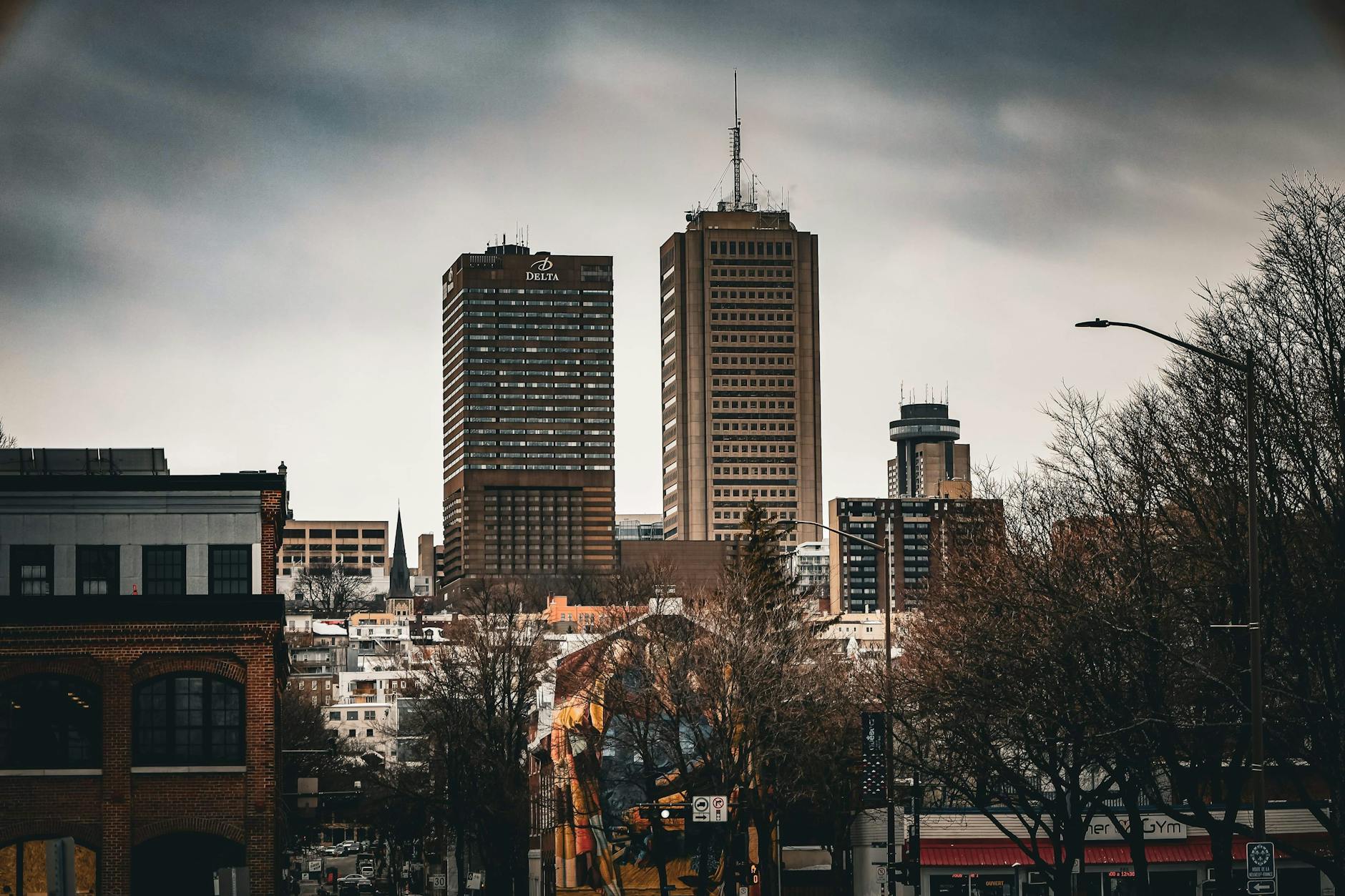 A modern urban skyline in Quebec City under a cloudy sky