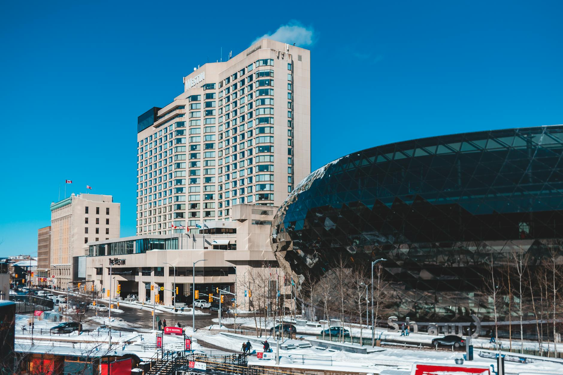 Winter cityscape with modern buildings under a clear blue sky