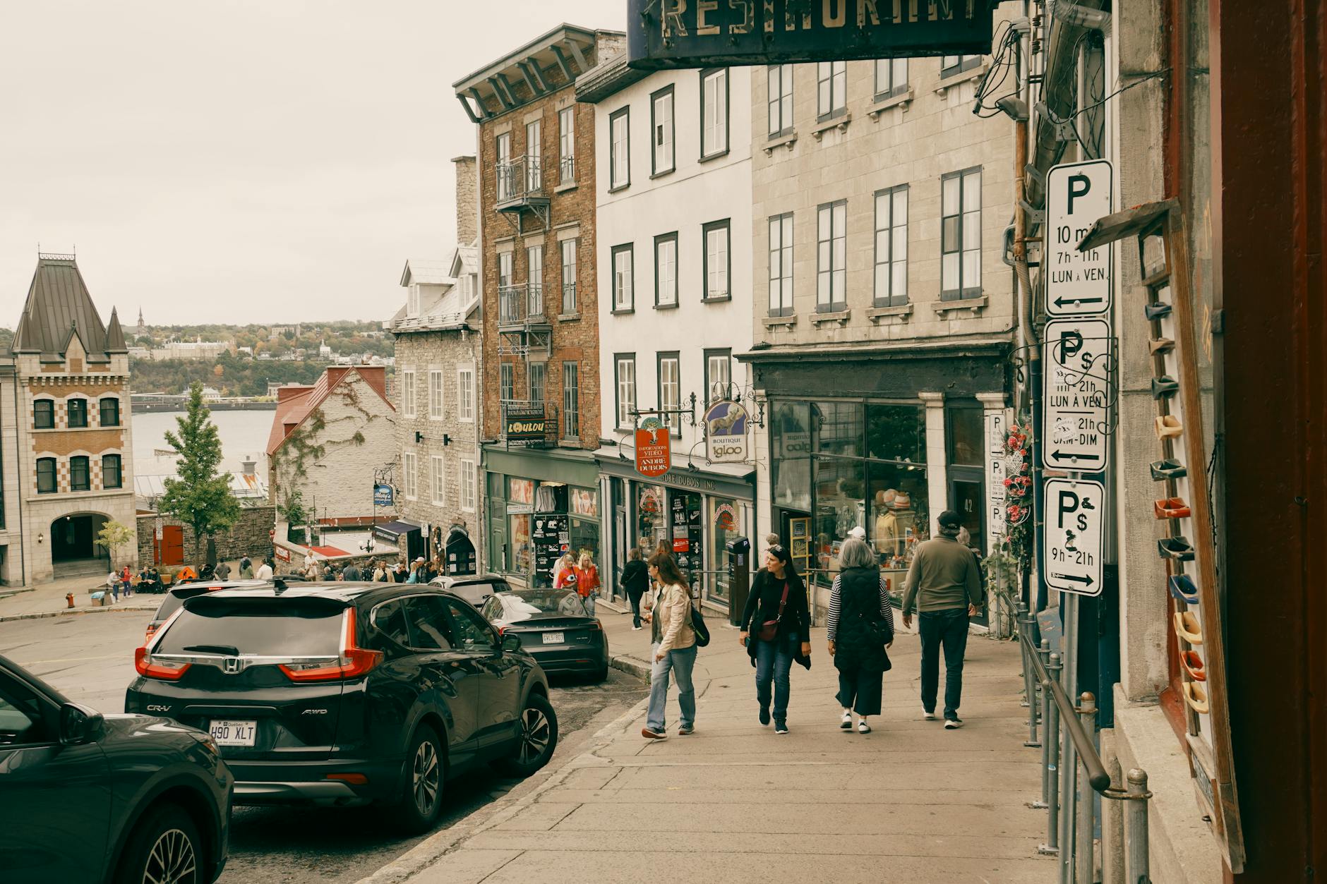 Historic Quebec City street with pedestrians near the river