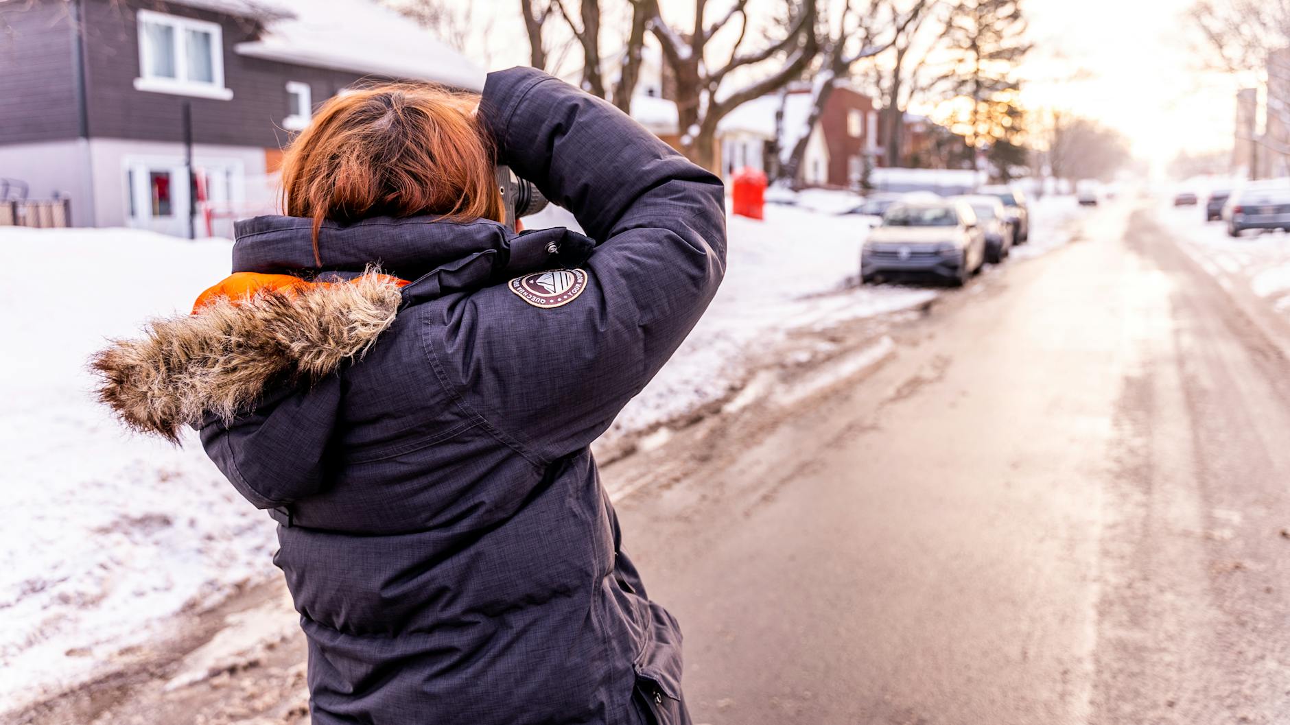 Photographer capturing a snowy Quebec City street scene