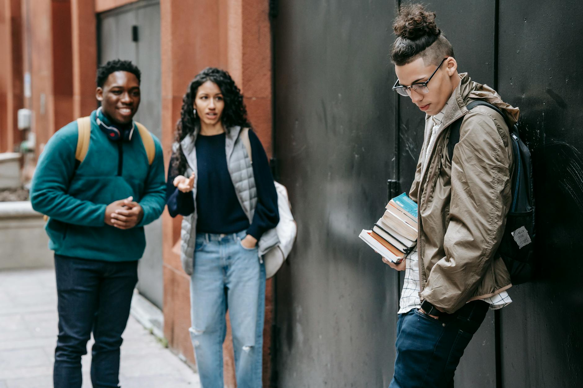 Students with backpacks standing near a university building