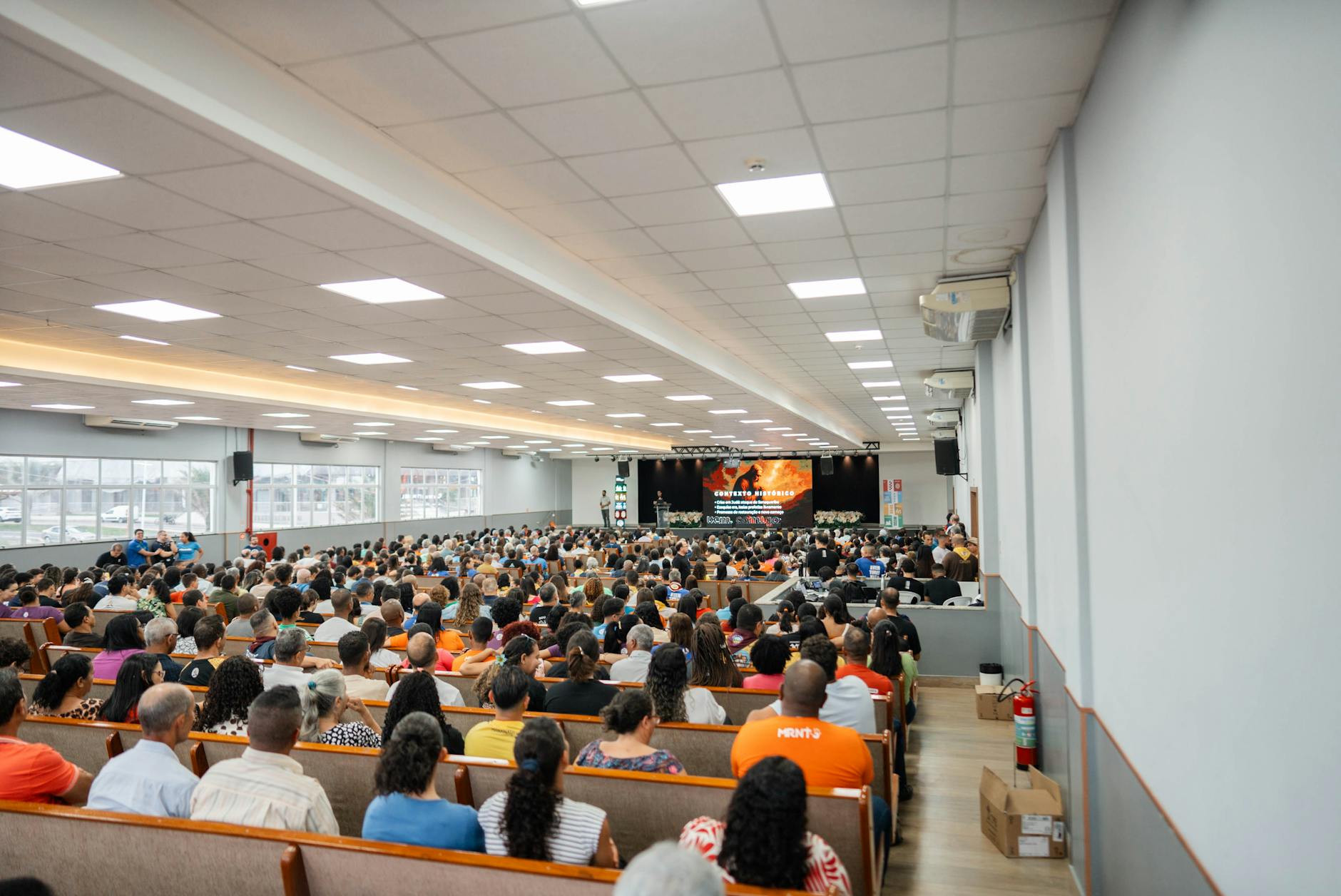 Large audience in an auditorium for a presentation