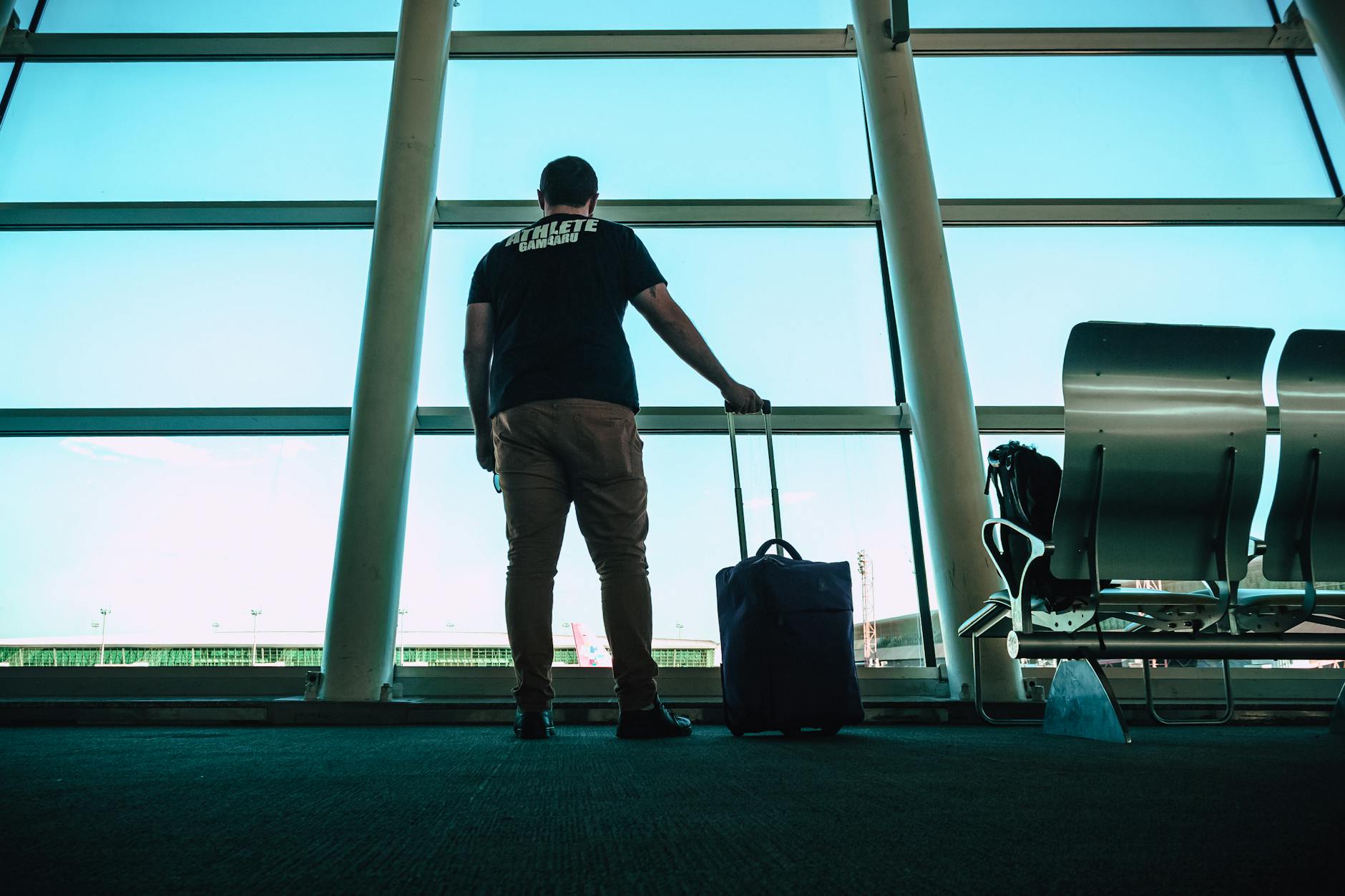 Traveler with luggage waiting in an airport lounge