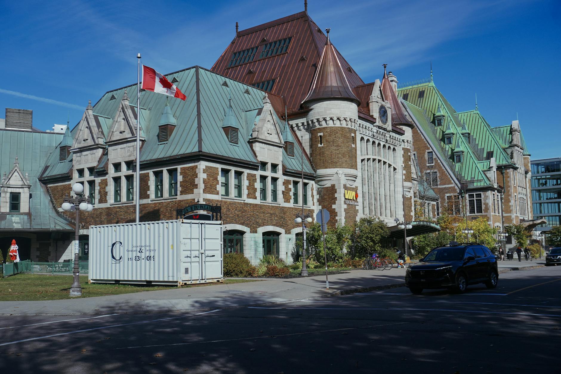 Historic Quebec building with Canadian flag under a clear blue sky