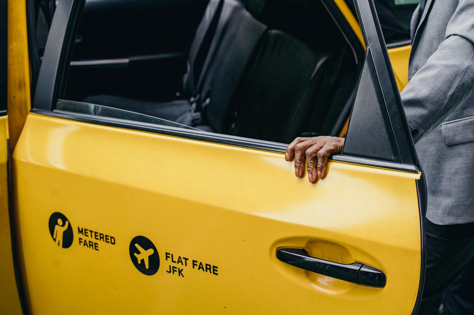 Traveler opening a taxi door