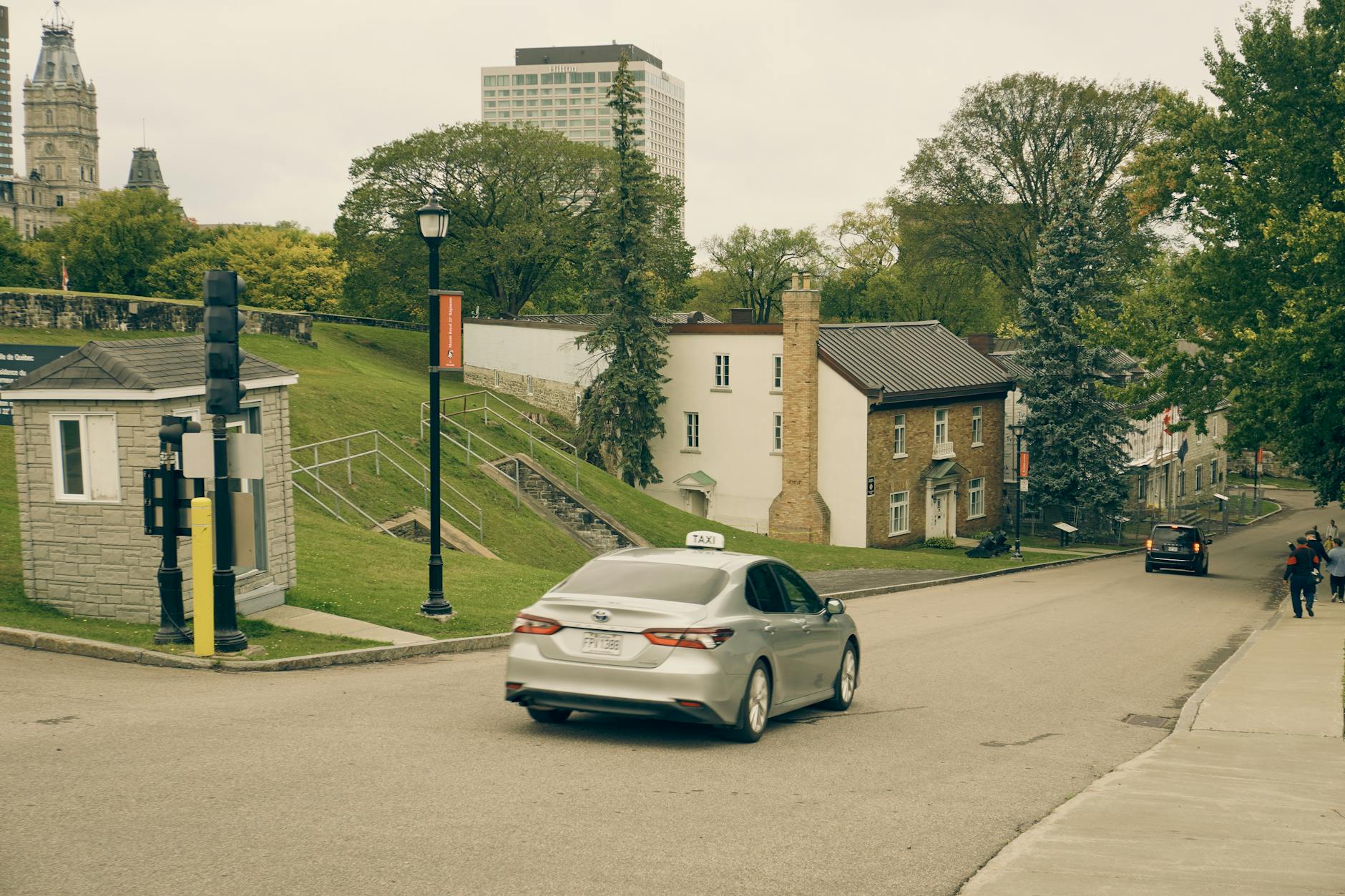 Taxi on a quiet Quebec City street with historic buildings