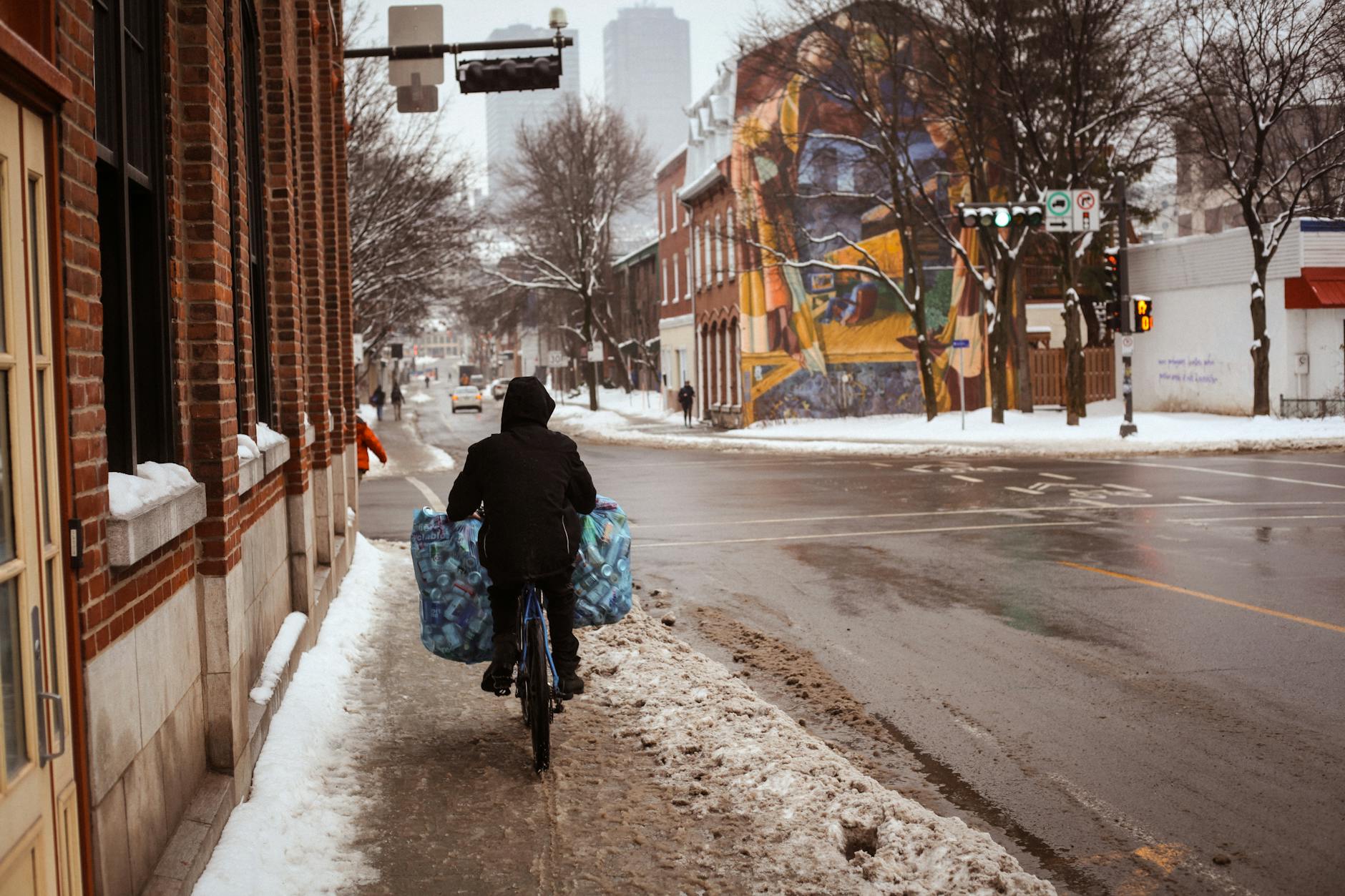 Person riding through a snowy city street in Quebec