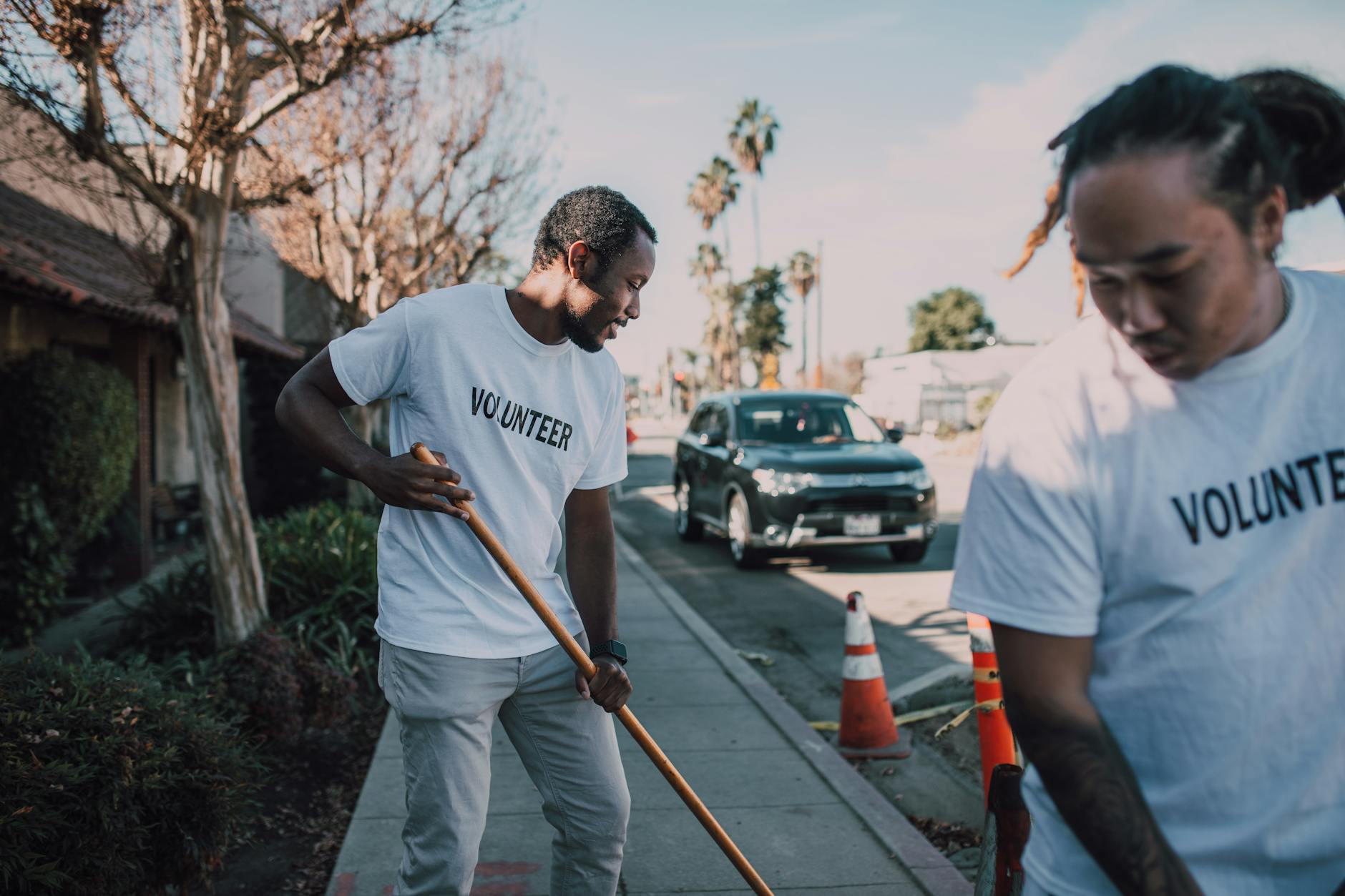 Volunteers working together to clean a sidewalk