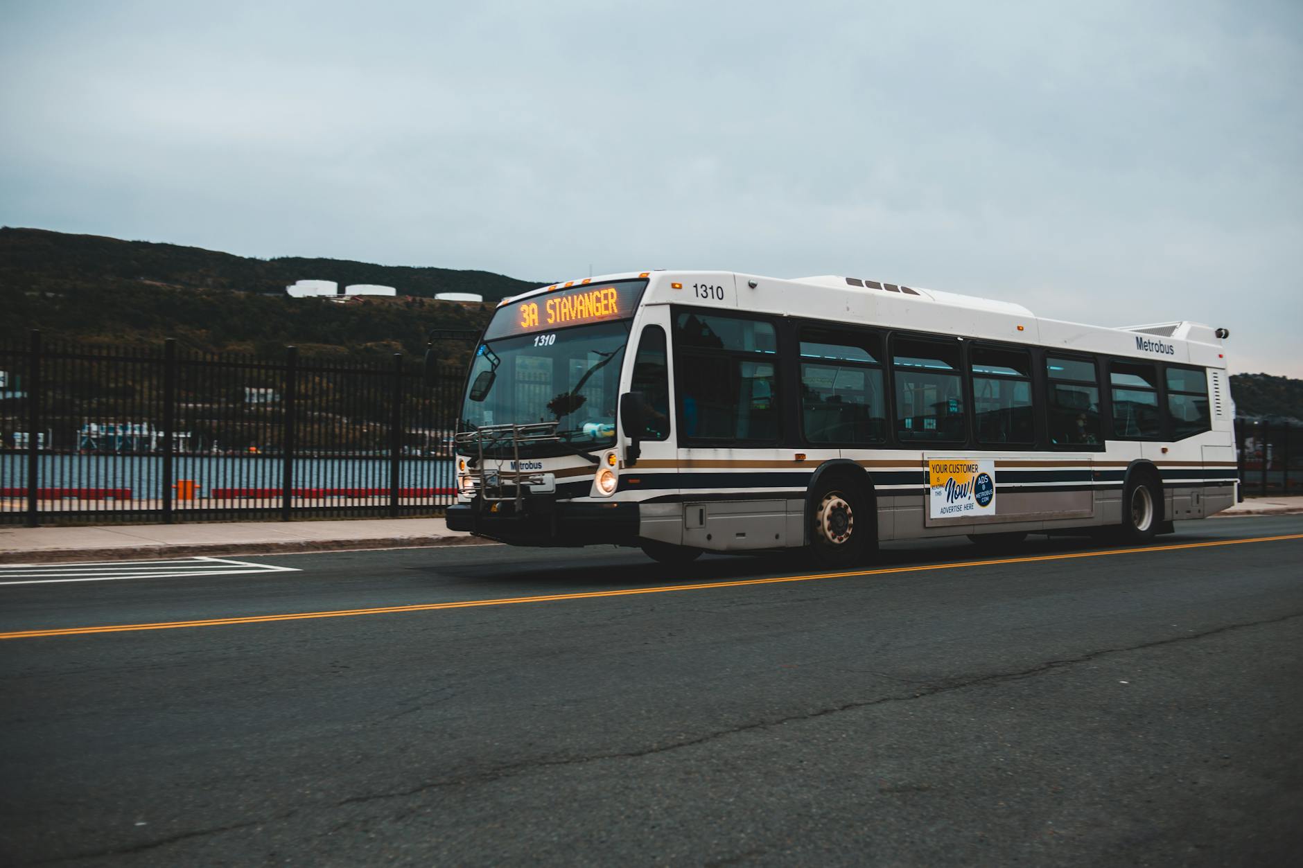 Bus on a Norwegian road for Stavanger budget transport planning.