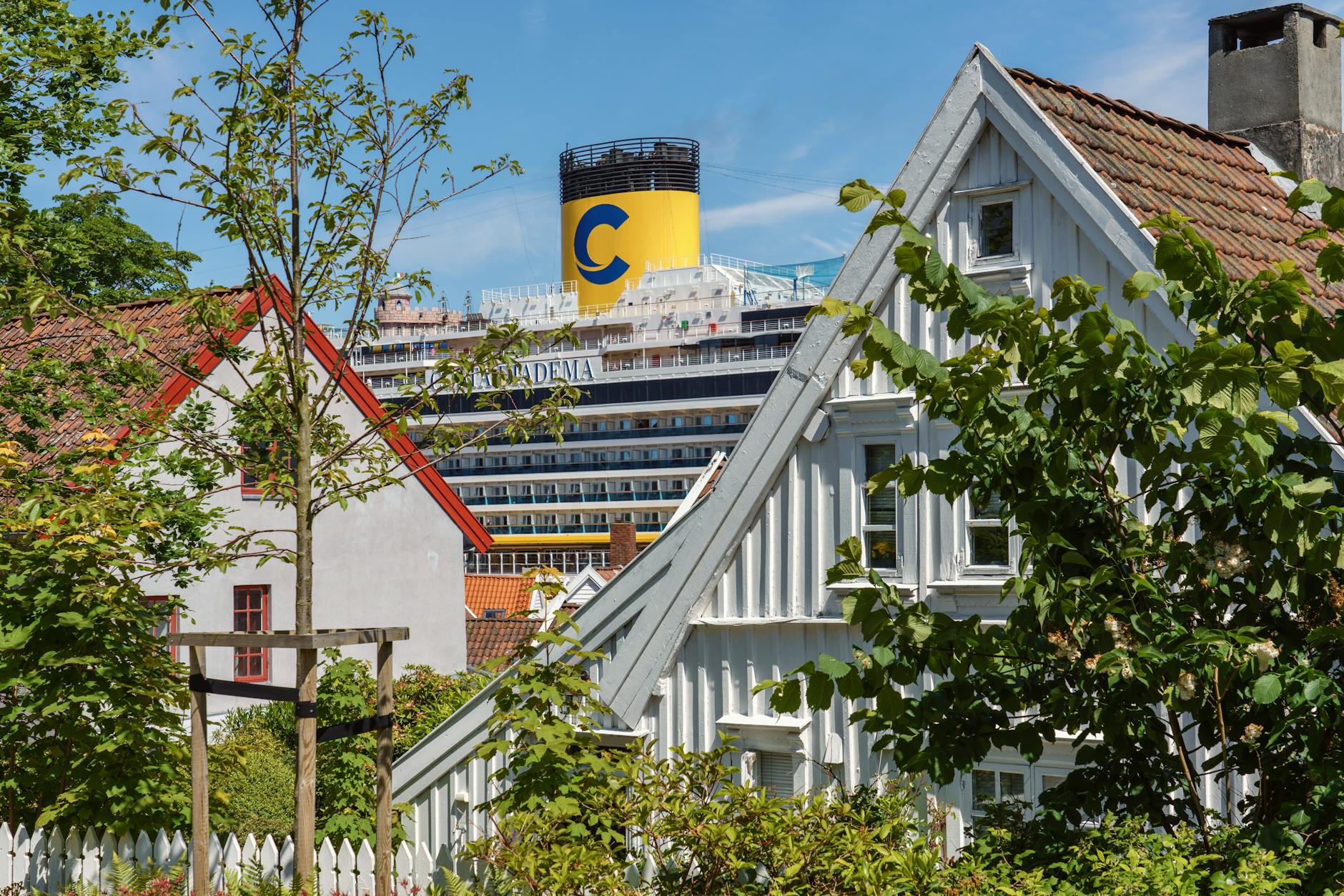 Stavanger houses with cruise ship in the background for departure planning.