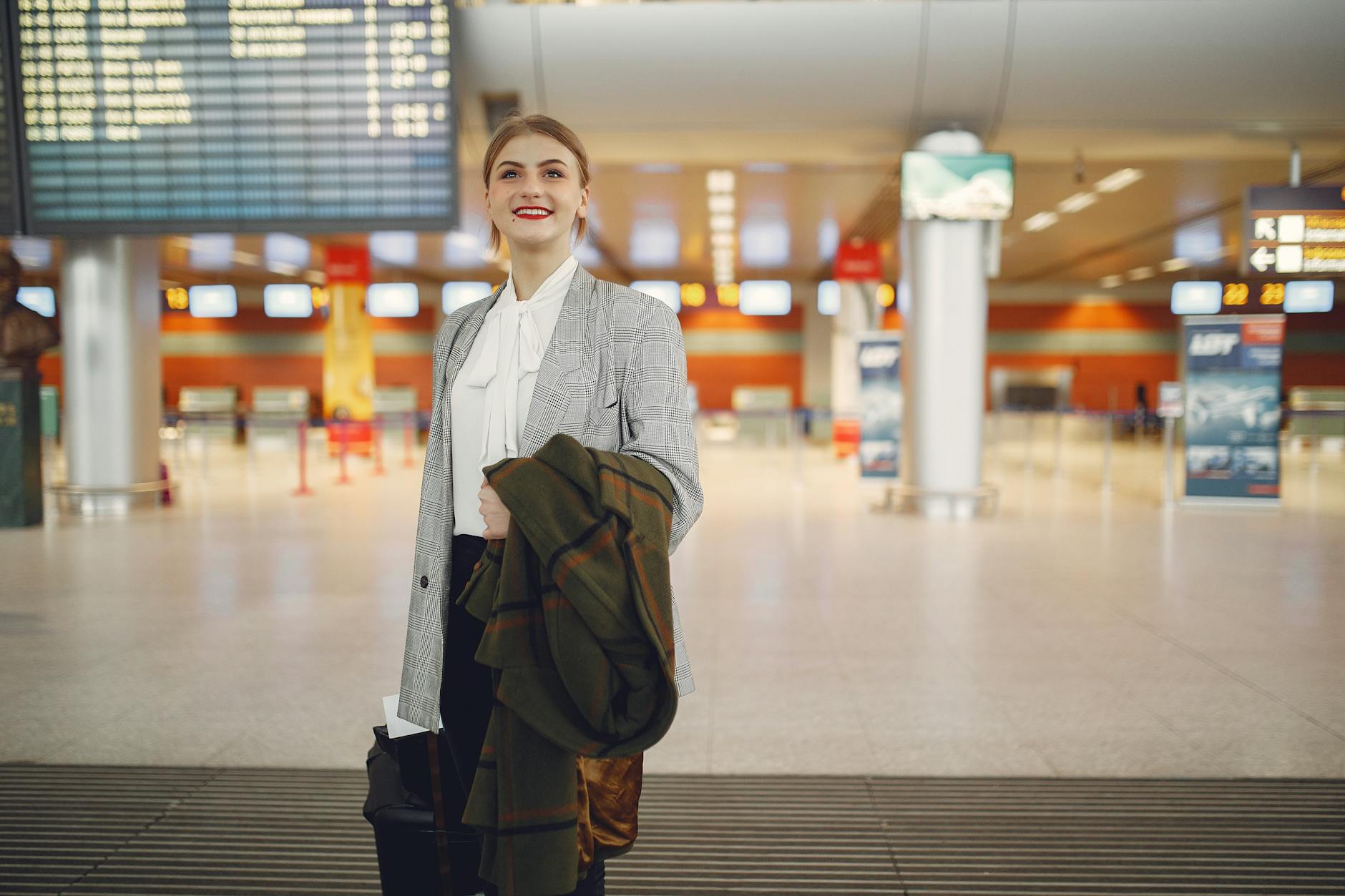 Business traveler checking airport board for Stavanger consultant arrival planning.