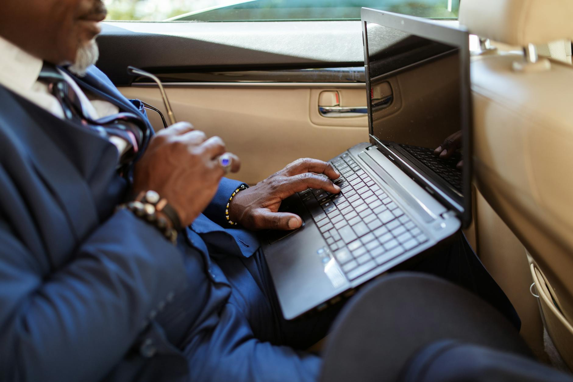 Business traveler typing on a laptop in transit for Stavanger consultant data planning.