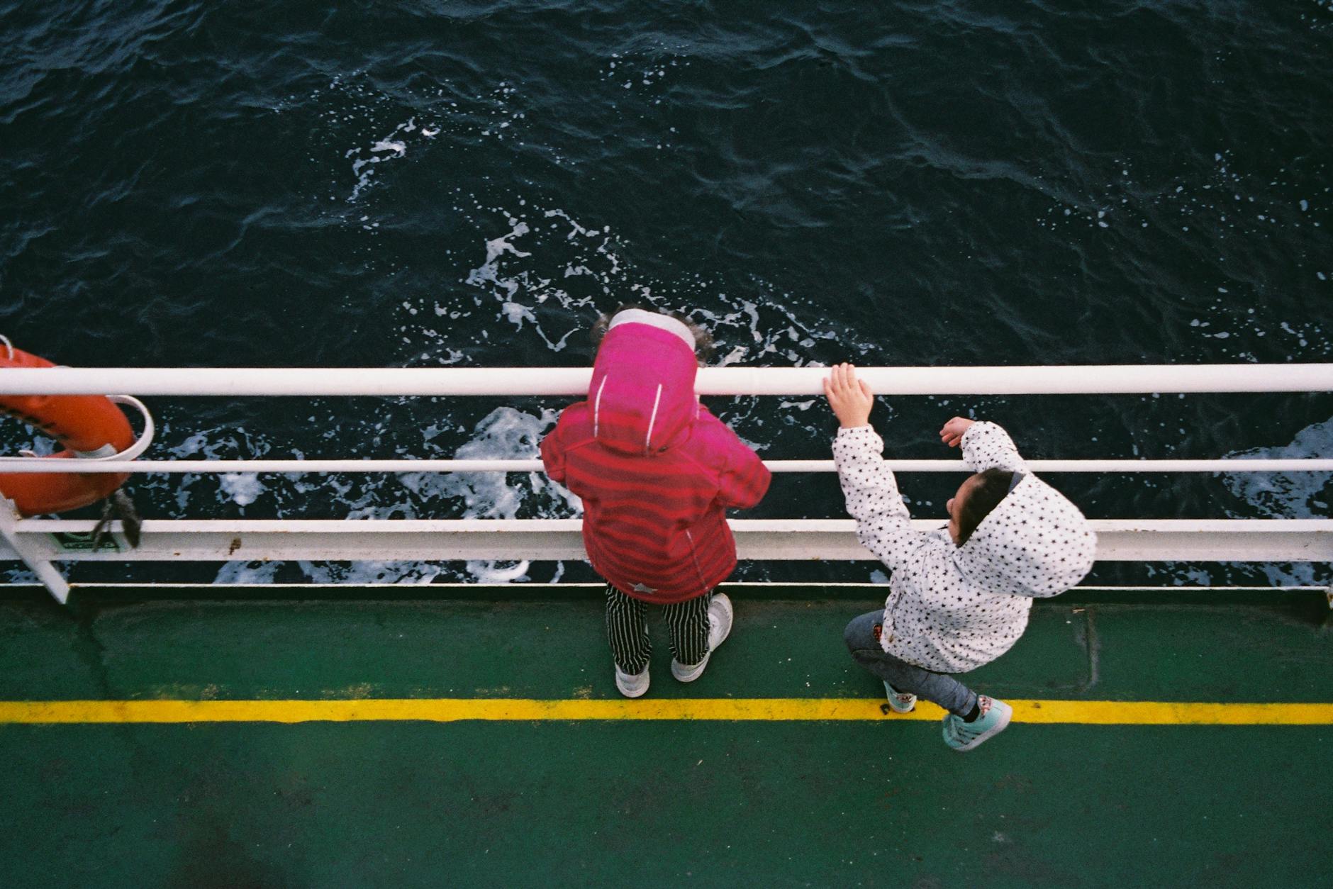 Children looking from a boat deck for Stavanger harbor planning.