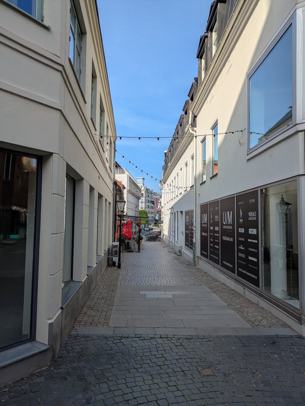 Quiet evening street with storefronts for Stavanger luxury dining planning.