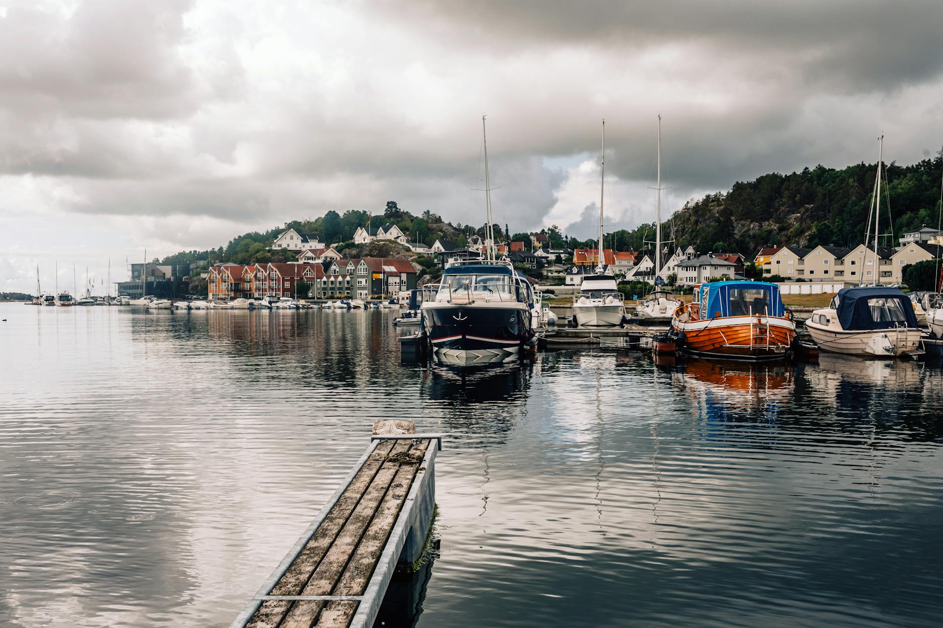 Norwegian harbor with boats for Stavanger trade-show weather planning.