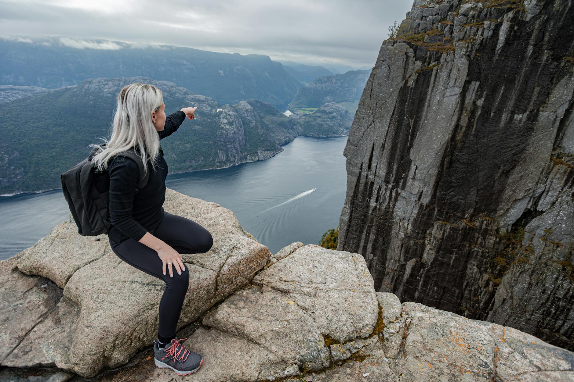 Woman overlooking a Norwegian fjord for Stavanger woman traveler planning.