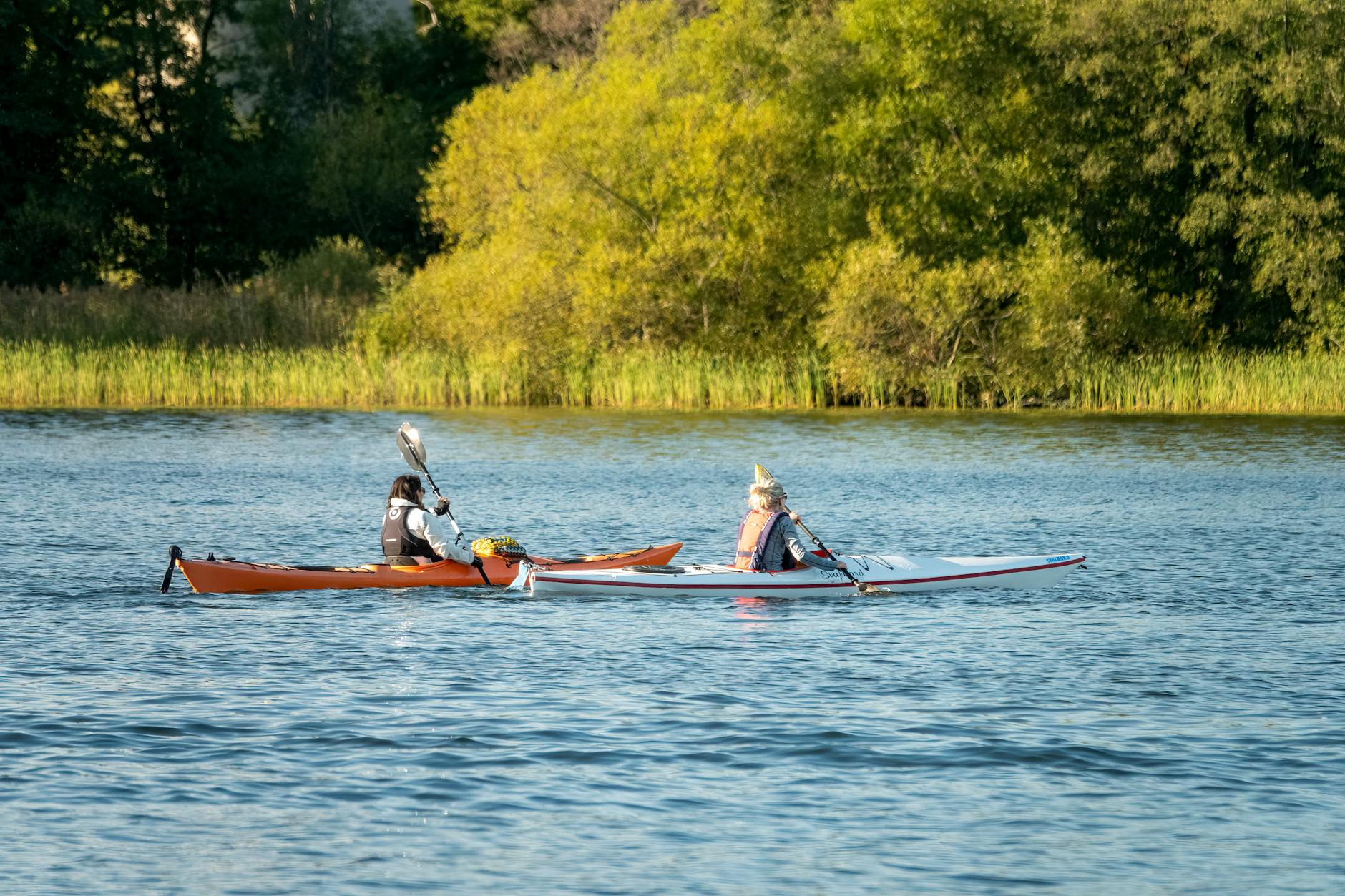 Kayakers on calm Stockholm water for outdoor base planning.