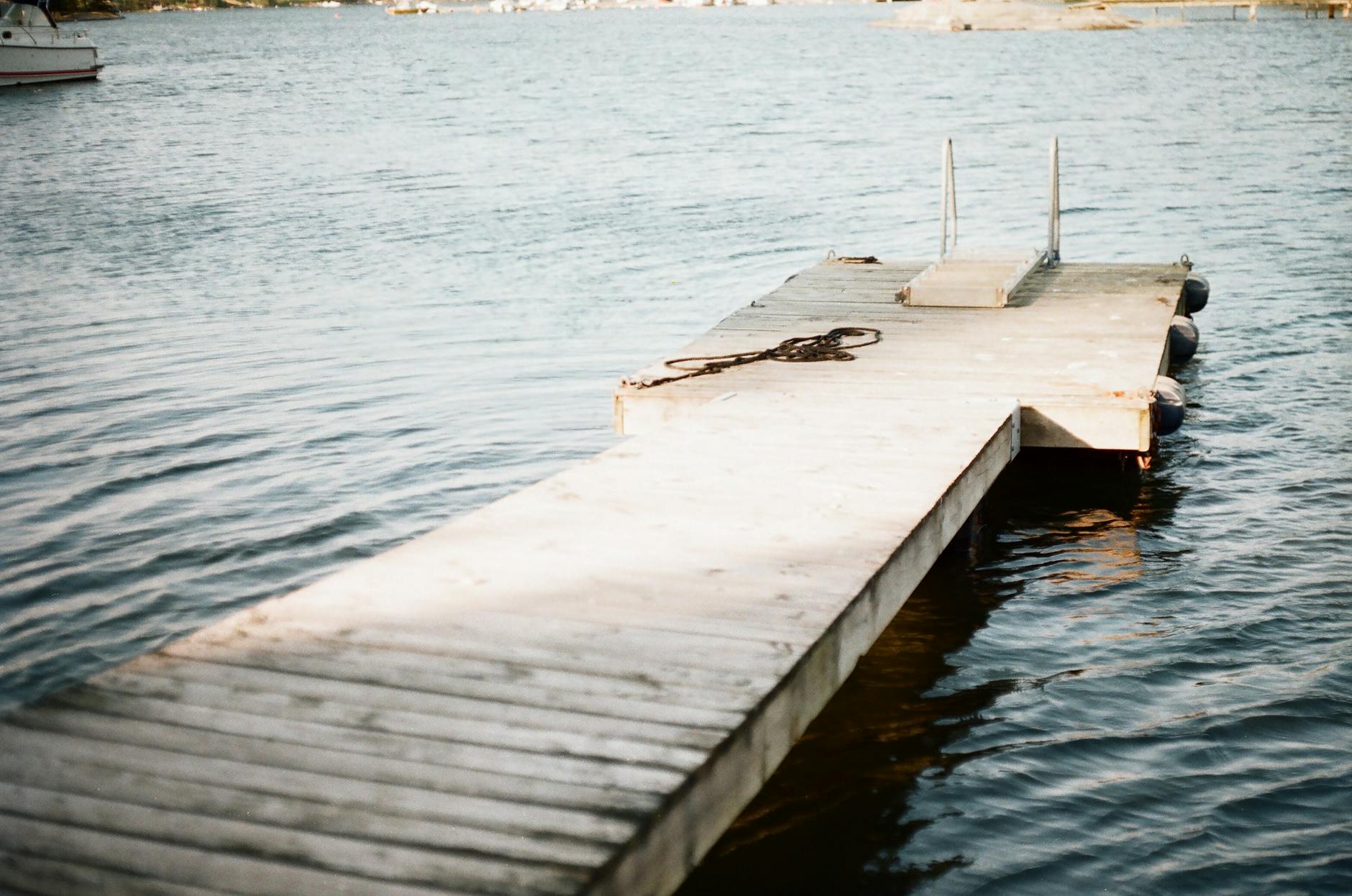 Wooden dock on a calm Swedish lake for outdoor recovery planning.