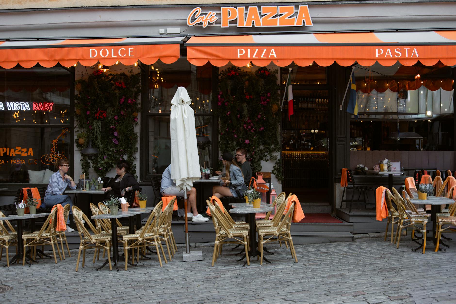 Outdoor cafe seating in Stockholm old town for budget meal planning.
