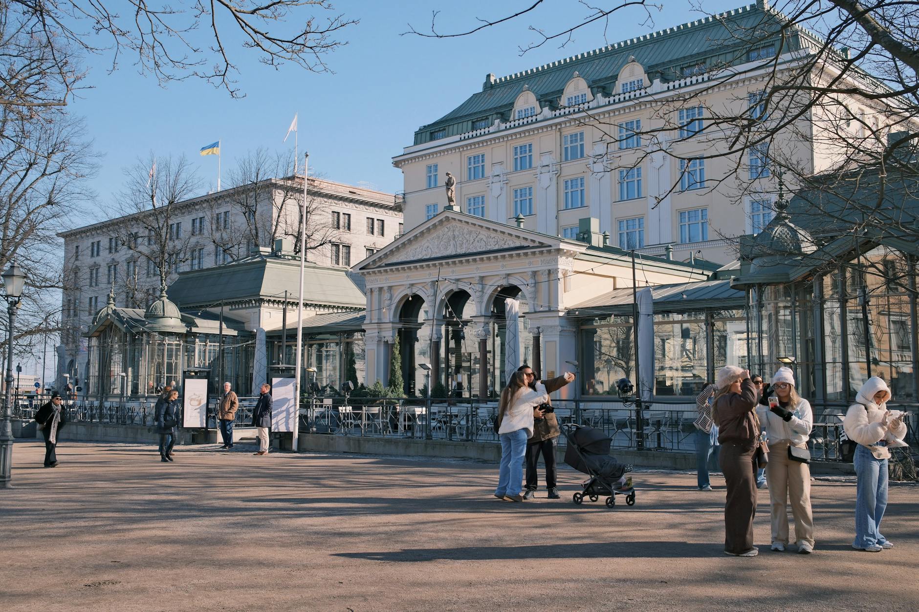 Sunny Stockholm square with people for family pacing planning.