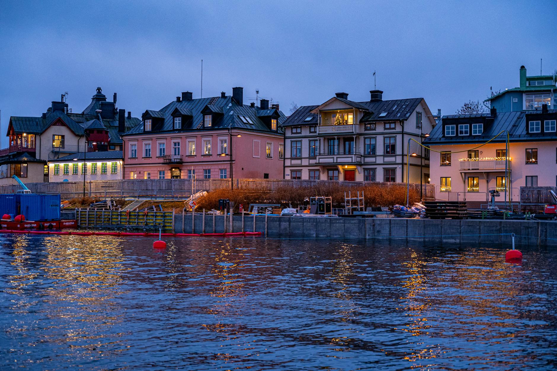 Stockholm waterfront houses at dusk for investor dinner planning.
