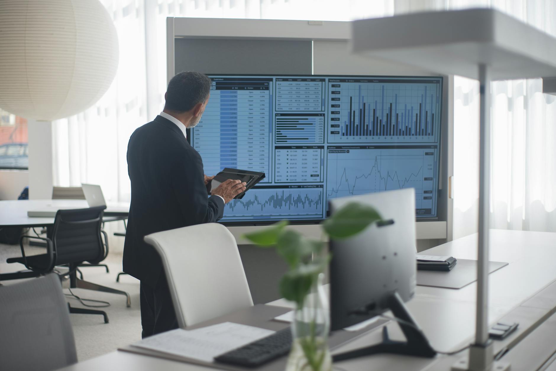 Professional reviewing financial screens for Stockholm confidential work planning.
