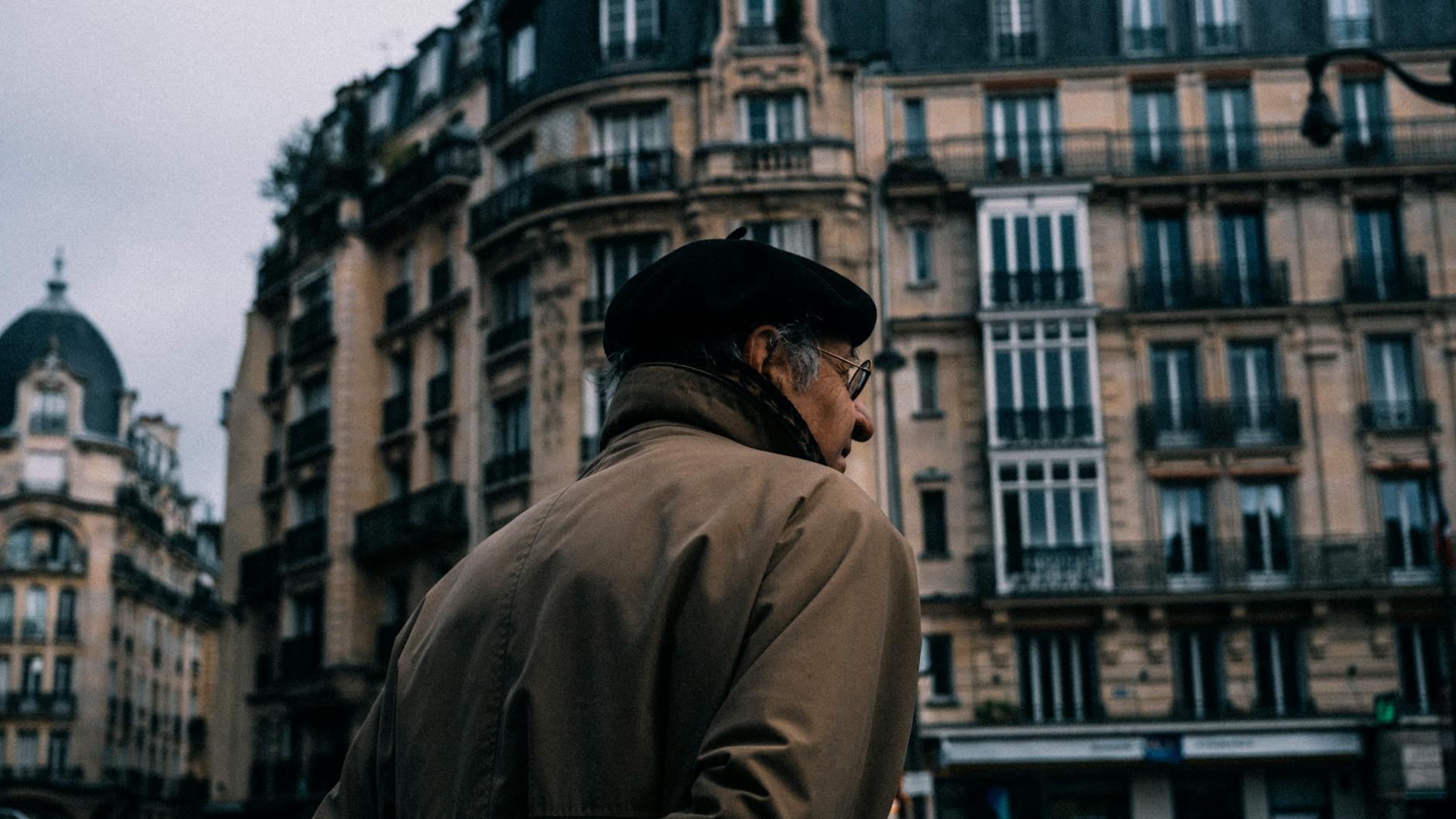 Older man walking in the city for Stockholm lodging access planning.