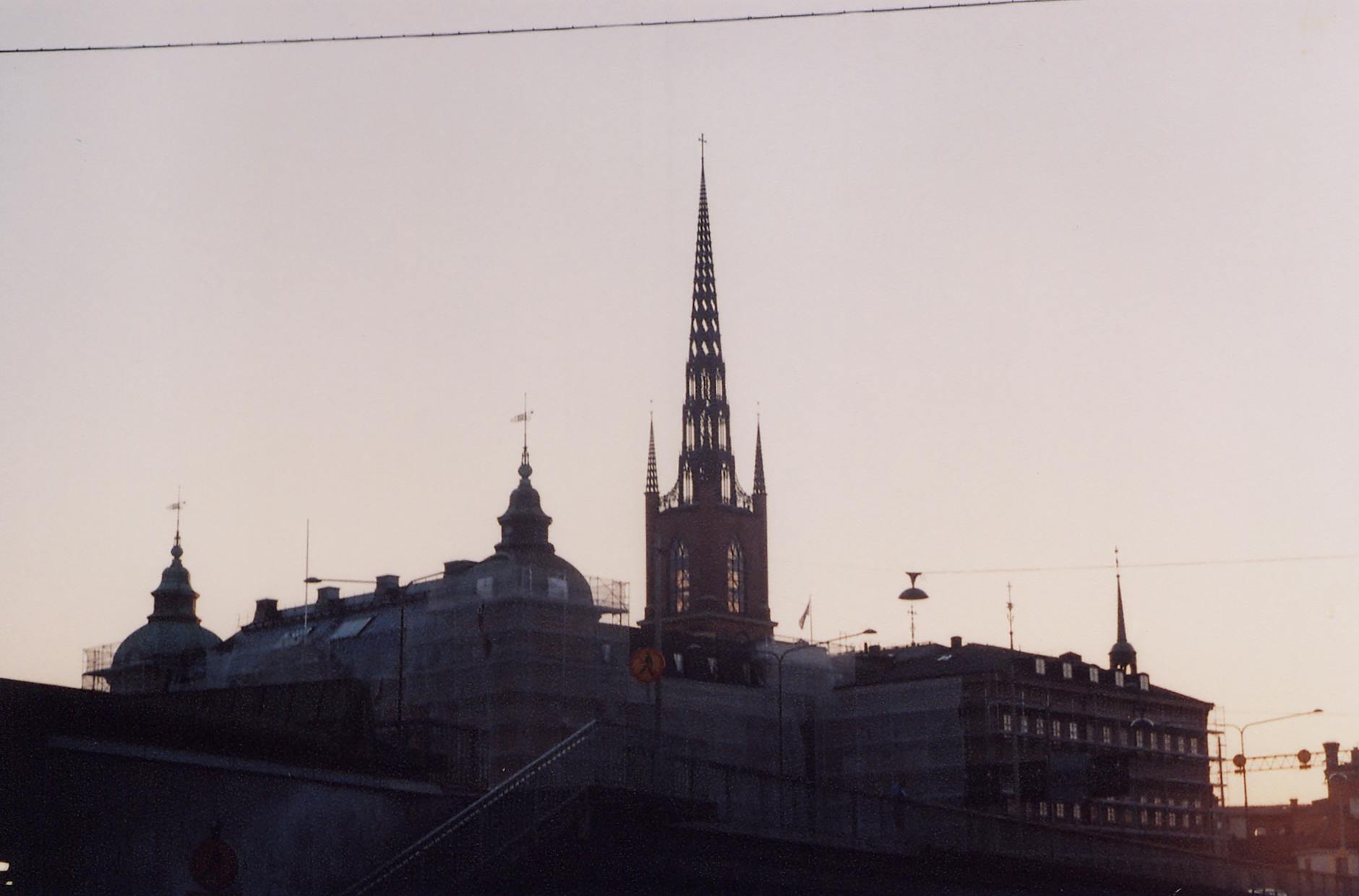 Riddarholmen Church silhouette at sunrise for Stockholm pilgrimage planning.