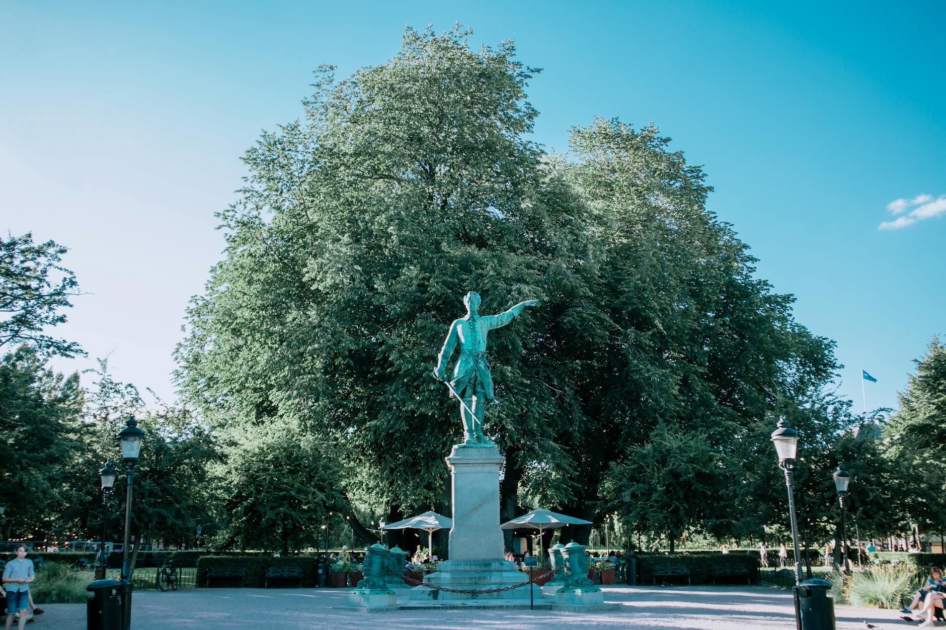 Sunlit Stockholm park statue for repeat visitor quiet-stop planning.