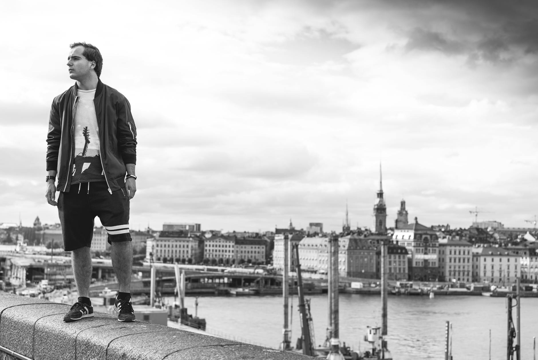 Student traveler on a Stockholm bridge for short-program budget planning.