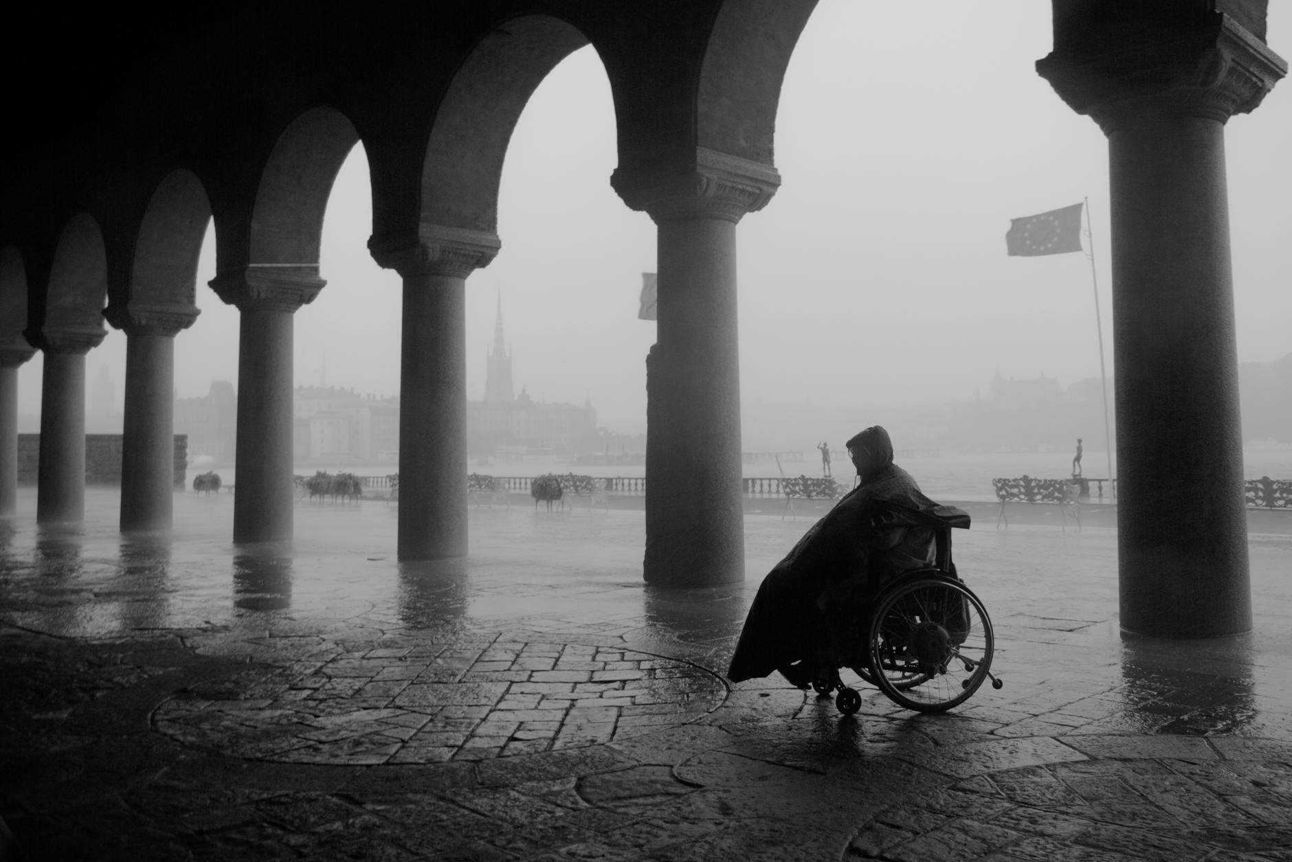 Traveler using a wheelchair under Stockholm archways for mobility planning.