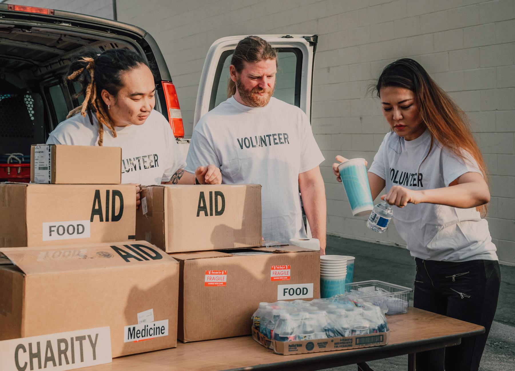 Volunteers organizing aid boxes for community context planning.