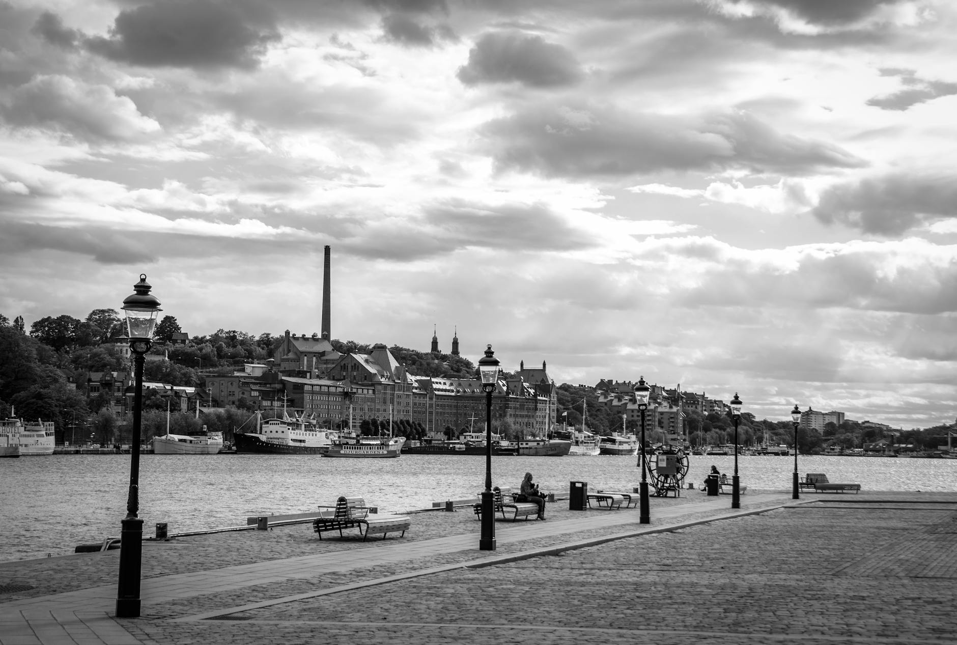 Benches by the Stockholm waterfront for woman traveler report planning.